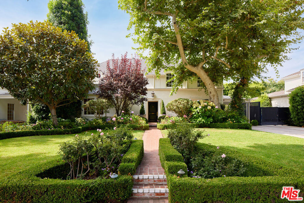 Introducing a truly magnificent and timeless residence in the heart of prime Little Holmby, available for the first time in 25 years. From the moment you approach, this exquisite traditional home captivates with its stately presence and enchanting, romantic landscaping. Stepping through the entrance, you're welcomed by a grand, time- honored foyer and a sweeping, dramatic staircase that sets the tone for this extraordinary property. The main level showcases an impressive array of living spaces: a gracious, step-down living room with a classic wood-burning fireplace, a vibey library/den complete with a wet bar, and a charming garden room that seamlessly opens to a secluded outdoor patio. The formal dining room is perfect for intimate gatherings, while the light-filled, newly renovated kitchen and adjoining family room offer the ideal setting for daily living and casual entertaining. Every detail has been meticulously crafted with functionality and storage in mind, ensuring both beauty and practicality. Ascending to the second floor, you'll find the sun-drenched primary suite-a spacious retreat with an inviting sitting room that offers sweeping garden views. The additional bedrooms are generously proportioned, each with its own en suite bath. The rear bedroom is particularly noteworthy, featuring a unique walk-in closet/office area that leads to a private patio, creating a serene and versatile space. Outdoor living is at its finest here, with the downstairs patio opening effortlessly from both the garden room and family room, making it perfect for alfresco dining and entertaining. The sparkling pool, framed by charming sitting areas, is complemented by a gazebo that evokes the glamour of Old Hollywood. The expansive garage and storage area present an exciting opportunity for conversion into additional living space or an ADU, catering to modern needs. Throughout the home, you'll discover an abundance of character: intricate moldings, rich wood-paneled walls, exquisite hardware, and thoughtfully designed window details. This residence is truly a rare gem -a blend of classic elegance, contemporary comforts, and undeniable charm, making it a once-in-a-lifetime offering.