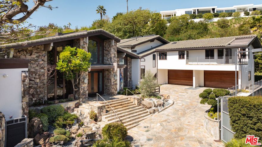 Nestled in the heart of prime Beverly Hills proper, this exceptional Bali-inspired mid-century estate offers the perfect blend of serene retreat and luxurious living. Privately situated behind double gates, the sprawling compound unfolds across an expansive lot, featuring breathtaking city views, lush landscaping, and an unparalleled sense of tranquility. Designed with a harmonious fusion of organic materials and contemporary elegance, the home boasts soaring wood-beamed ceilings, floor-to-ceiling windows, and an abundance of natural light that enhances its seamless indoor-outdoor flow. Grand living spaces are framed by striking stonework, rich wood finishes, and bespoke architectural details, creating a timeless ambiance of warmth and sophistication. The inviting outdoor spaces are designed for both relaxation and entertaining, with multiple lounge areas, a built-in dining platform, and a sculptural tree serving as the heart of the serene setting. A sun-drenched pool area offers a tranquil escape, while the estate's full-size tennis court provides an additional layer of exclusivity and recreation. Offering the utmost in privacy and security, this one-of-a-kind estate is a rare opportunity to own a true sanctuary in one of the most coveted locations in Los Angeles.