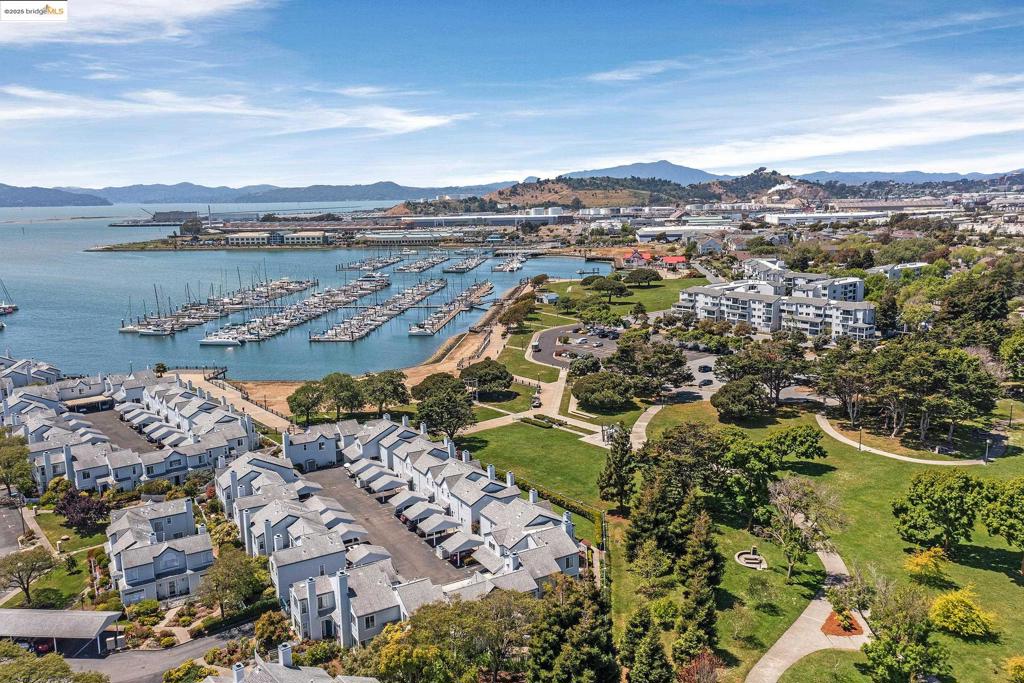 GREAT OPPORTUNITY! AMAZING UPDATED UNIT AT THE BEACH! Ready and waiting for you to make it your new home! The Beach" by the bay, overlooking a verdant, harbor-front park, in a two-story, two and a half bath, single-family home, affordably! Best of both worlds: gated community w/exterior and grounds maintained by the HOA, yet it lives and finances like a house (it’s not a condo)! This updated, sophisticated, light and serene townhome offers a warm, relaxing fenced courtyard bathed in midday sun and colorful twilights across big skies stretching far to the West. Open, airy living spaces, big windows, high ceilings, beautiful floors and a fireplace all on the ground level, plus two ensuite bedrooms upstairs offering vaulted ceilings, roomy closets and private baths. Park at your back door, yet live right on the Bay Trail, just 1.5 miles down from the SF Ferry, Tradewinds Sailing Club next door, nearby dining & breweries, and quirky, charming, little-bit-of-everything Point Richmond keeping life fresh and lively in this tucked away haven.