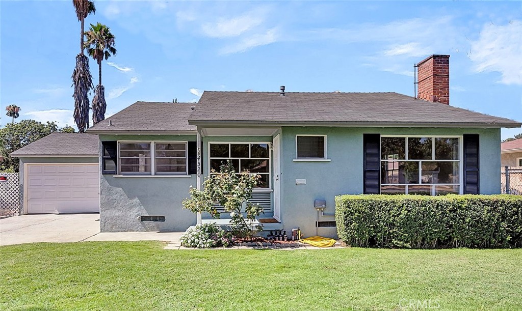 Welcome to this delightful 2-bedroom, 1-bathroom cottage in the heart of the highly sought-after "Wood Streets" neighborhood. Blending vintage charm with fresh updates, this partially renovated home features all new flooring and carpeting, fresh interior paint, new window coverings, and a brand new automatic sprinkler system with lush green grass. Enjoy the comfort of central air and heat, and a cozy living room with a wood-burning fireplace. The home boasts a formal dining room, charming built-ins, and an eat-in kitchen with tile countertops. One bedroom offers a private exterior entrance—perfect for guests, or easy access to the backyard. Outside, the cute entry overlooks a wide, tree-lined street with plenty of parking, plus a private driveway with potential RV parking. The 2-car-sized garage has been newly painted floor and walls, and includes laundry hookups, LED lights, auto rollup door, and a newer water heater. There's ample space in the pool-size backyard, with the potential to create drive-through access from the garage, and plenty of room to add a garden, pool, or even an ADU. This well-loved home has been in the same family for many years and is now being offered for sale through a trust. Located walking distance from Bonaminio Park, Mt. Rubidoux hiking trails, the Santa Ana River bike path, the Riverside Plaza, and a short drive or bike ride to downtown Riverside. This home offers not just a place to live, but a lifestyle rooted in community, nature, and charm. The Wood Streets neighborhood is known for its friendly neighbors and timeless character. Don’t miss this opportunity to own a slice of Riverside history with touches of modern comfort!