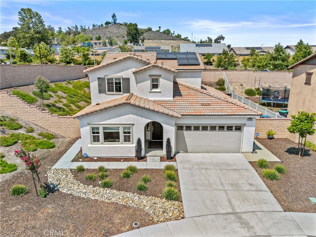 This stunning NEXT-GEN Smart Home sits on a private END Lot with over 11,000 sq ft of versatile space and RV PARKING potential…a RARE find in Audie Murphy Ranch! Built just 3 years ago, this almost NEW 4 Bed/3.5 Bath Home offers 2,400+ sq ft of living space and is the perfect combination of Modern UPGRADES, thoughtful Design, and FAMILY-FRIENDLY Features. The downstairs ADU, equipped with a Private Entrance and its own Living Space, Kitchenette, Bedroom and Laundry, provides comfort and privacy for Family/Guests or INCOME EARNING Potential. Inside the home, Neutral LVP Flooring flows seamlessly throughout, complemented by abundant Recessed Lighting making every space feel BRIGHT and inviting. The OPEN-Concept Kitchen is a dream with sleek Quartz Countertops, ample storage, and an Island perfect for entertaining or casual dining. Upstairs you will find 3 more Bedrooms, a LOFT area with the perfect spot for a Built-In Desk, and the Laundry Room…adding functionality and convenience to your daily routine. Step outside into the expansive backyard built for ENTERTAINING and enjoying life outdoors. The permitted Alumawood Patio Cover with integrated lighting creates a stylish and shaded area for dining or relaxing. Kids will love the In-Ground Trampoline and Sand Playground, while adults can unwind around the gravel Fire Pit Area…a cozy spot for evenings under the stars. This generously-sized Corner Lot provides plenty of room to expand and grow...whether it's an elevated SPA, built-in BBQ island or RV Parking with an oversized Gate...the possibilities are endless! Additional features include a 3-Car TANDEM Garage, PAID OFF Solar Panels, and a Smart Home and Security System Panel…combining energy efficiency with peace of mind. Located in the most desirable neighborhood of Menifee, between the 15 and 215 Freeways, you'll enjoy Resort-Style Amenities: Clubhouse, Pools, Tennis and Basketball Courts, Sports and Skate Parks, beautifully maintained Walking Trails and plenty of Greenbelts. Don’t miss this opportunity to own a MOVE-IN READY Home in a true COMMUNITY…built for Connection, Recreation, and Comfort!