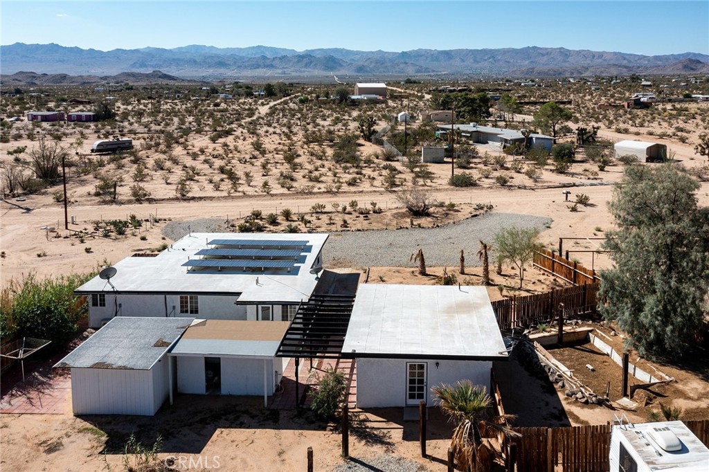 Spacious Newly Remodeled and Updated 5-Bedroom, 3-Bathroom home, including the detached, private Casita. Fully-paid solar. Work completed with Permits. Expansive 2.5-Acre parcel, bordered on the northern boundary by government-owned land providing a wilderness/privacy barrier. Views to the south of the ridgelines of Joshua Tree National Park – only a short drive away, or hike out the front door into the desert. Home has never been lived in since complete remodel, providing buyer a clean slate. Many possibilities including purchasing as a primary residence with the option to rent out the casita extra rooms to help pay the mortgage, or a long-term investment rental, or a private vacation getaway supplemented by Airbnb rentals. Includes a unfinished trailer that could act as an extra room. New ductless mini-split AC/Heaters throughout. Custom installed floor-to-ceiling tile in each bathroom. New flooring. New cabinetry and counters throughout. Clean, well-lighted integrated indoor/outdoor living, with private porch off the primary bedroom suite. Rural location, yet only minutes to downtown for dining and shopping. Perfect for a large, extended family or group purchase with friends or family to secure your desert dream.