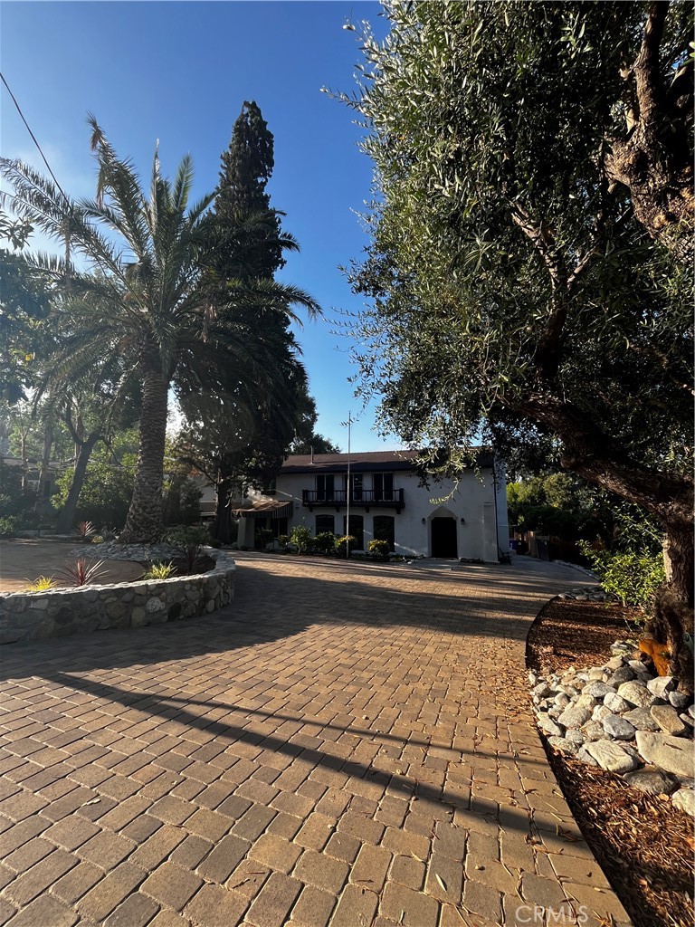 Welcome to 2430 Orange Avenue, a beautiful Spanish style single family home on a huge 11,121 sq ft lot in the sought-after La Crescenta neighborhood. This captivating 3-bedroom, 3-bathroom, 2-story residence has been lovingly cared for by the same family for many years and it possesses a very special peaceful vibe. It features 2190 sq ft of thoughtfully designed living space, combining comfort with modern elegance. As you enter, you'll be greeted by a spacious living room with laminate floors, recessed lighting, and an inviting wood burning fireplace. The open concept living area includes 3 picture perfect windows that showcase scenic views of the large freshly redone front landscape that creates a bright and airy atmosphere. The living room flows seamlessly into a generous dining area with a sparkling crystal chandelier. There is one bathroom downstairs and a family room/den. The updated kitchen is a chef's dream, showcasing modern cabinetry, all NEW stainless-steel appliances, quartz countertops, and a perfect island with pendant lights. Upstairs you will find 3 bedrooms and 2 bathrooms with gorgeous views of the city lights, hills and mountains. The property features central air and heating, a NEW refrigerator, NEW dishwasher, NEW stove, NEW washer & dryer and NEW landscape drip system. The expansive backyard with a POOL is complete with a large cement patio with a pavilion cover and is ideal for gatherings and relaxation. It has a 2-car detached garage and ample front and backyard driveway parking. Located north of the 210 freeway, you'll have easy access to parks, hiking trails, shops, and top-rated schools like Monte Vista Elementary, Rosemont Middle and Crescenta Valley High. Don't miss this incredible opportunity to own a move-in-ready home in a welcoming and established community.
