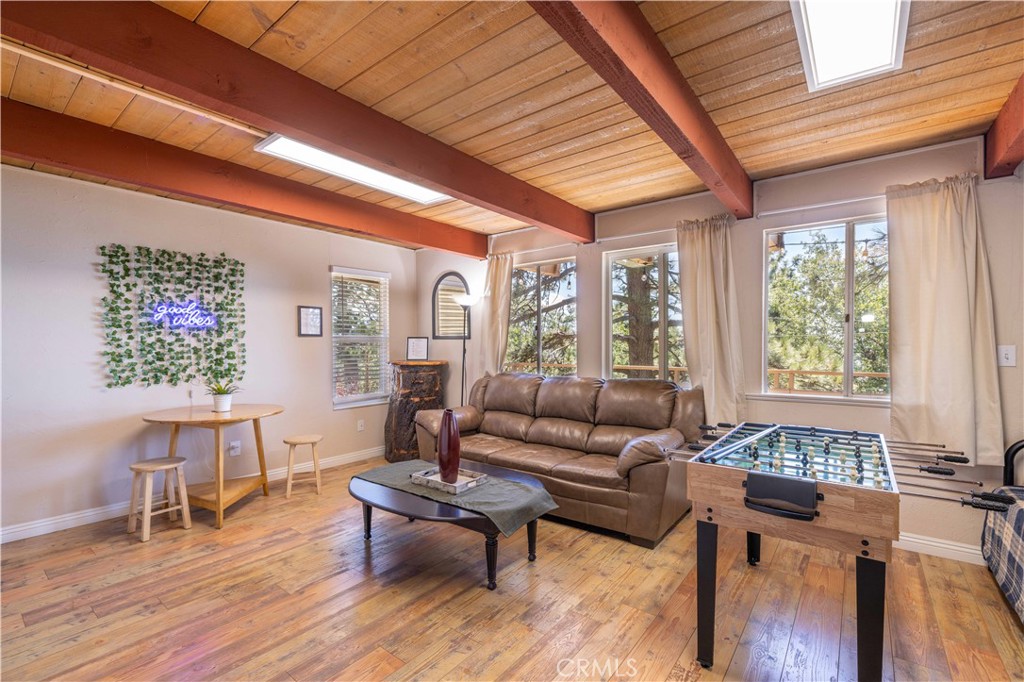 Panoramic View of the Valley below from the extra large deck!!!
31616 Panorama Drive in Running Springs is a classic 1973 A-frame cabin featuring 2 bedrooms and 2 bathrooms with 1,712 square feet of living space. The home offers an open-concept living and dining area with vaulted ceilings, wood accents, and large windows that fill the space with natural light. A stone fireplace adds warmth and charm, while the eat-in kitchen provides plenty of space for cooking and entertaining. Both bedrooms are generously sized, with one on the main floor and the other upstairs for added privacy.
The property includes a covered front porch and a private outdoor patio surrounded by trees, perfect for enjoying the mountain setting. Additional features include central heating, a paved driveway, and a functional layout that’s ideal for a full-time residence or a weekend getaway.
Located just minutes from Snow Valley Ski Resort, SkyPark at Santa’s Village, and Heaps Peak Arboretum, the home offers convenient access to year-round outdoor activities like skiing, hiking, biking, and fishing. Local restaurants, coffee shops, a community center, and Highway 18 are all nearby, making this a desirable location in the heart of Running Springs.