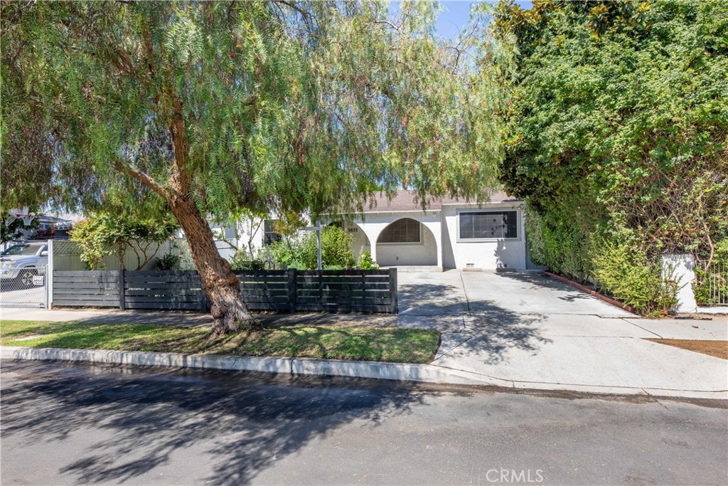 Set in the heart of desirable North Hollywood is this 1870 sq ft 3 bed 2 bath home with an additional 411 sq ft soundproofed recording studio in the back garden with an additional 375 sq ft covered carport.Hardwood floors throughout with the exception of the sun room which is tiled.Gas burning fireplace in the comfortable living room. Stainless steel appliances,granite countertops.Remodeled bathrooms with the primary having all new units and large walk-in shower. Large walk in closet in primary. Newly installed "pantry closet" in dining area.Opposite side of the house has 2 bedrooms and bathroom all off one hallway. Going towards the back of the house is a very large sun room which is tiled and has wrap around windows to enjoy the view of the back garden and the fruit trees, grapefruit,orange,lemon and avocado.In the backyard is a soothing waterfall also strung fairy lights, with 2 grassed areas separated by hard surfaced area for enjoying the fire pit. Then there is the soundproofed studio and covered carport which is great for outdoor entertaining in the shade. There is a storage shed in its own area off the back yard where the tank less water heater is situated on the side of the house. There is a double gate leading on the the service alley way. Just a block to North Hollywood's favorite dogpark and a few blocks to good transit service. This is a lovely move in property with much spent to keep it in top condition and a full list of recent improvements can be supplied on request.