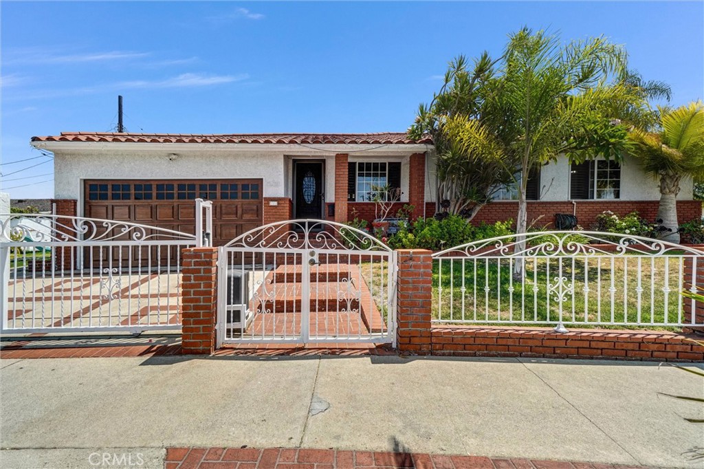Curb appeal at its finest! This corner lot home, surrounded by palm trees, has California woven into the outdoor flow. Its Spanish-style is blended with comfort and charm, truly a property not to be missed. You can appreciate how exceptionally its been well-kept throughout the spacious open floor plan. The kitchen offers a cozy eating area, unique tile counter tops and custom cabinetry with ample storage space. From the kitchen you can step down to the family room, ideal for those special occasions or step into the inviting living room and entertain your guests. All 3 bedrooms are thoughtfully designed for comfort and privacy and the 2 full bathrooms have been updated with modern fixtures. A generous and secure 2 car garage is seamlessly connected to the home, perfect for daily ease and storage needs. This property is nestled on a 5675 Sq. Ft. Lot, located near major freeways, LA/LB Ports, restaurants, schools and LA Harbor College and Golf Course. Enjoy all of the benefits Wilmington has to offer. Its The Heart of the Harbor.