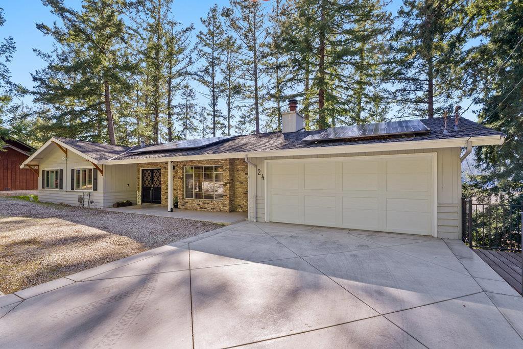 Huge Price Adjustment! The sellers have found their next home and are highly motivated! This spacious 4-bedroom, 3-bathroom retreat is nestled in scenic Felton, surrounded by majestic redwoods and natural light throughout. Enjoy an open-concept layout featuring vaulted ceilings, a cozy fireplace, and an updated kitchen with stone countertops, a tile backsplash, pantry, and ideal entertaining space. Guests will love gathering around the breakfast bar, dining area, or stepping out onto the expansive deck for seamless indoor/outdoor living. The multi-level design includes a second family room or home office, along with two bedrooms and a full bath downstairs perfect for guests, extended family, or flexible use. The backyard is a dream with raised garden beds, a chicken coop, fire pit, and play set plenty of room to grow, play, and relax. Enjoy significant utility savings with owned solar panels and a private water system. Just minutes from Henry Cowell Redwoods State Park, historic Roaring Camp Railroads, and the iconic Santa Cruz Beach Boardwalk. This must-see home offers the perfect blend of comfort, character, and convenience.