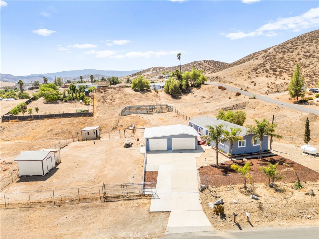 Charming & Fully Remodeled Manufactured Home on Horse Property – Must See! This unique and beautifully updated 3-bedroom, 2-bath manufactured home sits on a spacious 0.81-acre lot of horse property and features a private 1-bedroom guest unit—perfect for visitors, extended family, or rental income. Surrounded by stunning views and peaceful landscapes, this home has been completely remodeled from top to bottom after a fire, offering a fresh, modern living space you'll love: new dual-pane windows and flooring throughout (Mohawk Puretech planks) , stylish shaker kitchen cabinets with quartz countertops, new stainless steel appliances and a breakfast bar, updated drywall, baseboards, doors (interior and exterior), modernized bathrooms with walk-in showers and a luxurious jetted tub, a brand-new A/C unit and furnace for year-round comfort, and fresh paint inside and out. Enjoy outdoor living with two large decks—perfect for relaxing or entertaining while taking in the breathtaking sunset views. The property also includes a detached 2-car garage with a new garage door, ample parking for RVs, trailers, and toys, and space for sheds, a chicken coop, and all your animals. This move-in-ready gem is ideal for families, hobby farmers, or anyone looking for a little extra space and country charm—without sacrificing modern comfort. Don’t miss your chance to own this one-of-a-kind home—schedule your showing today!