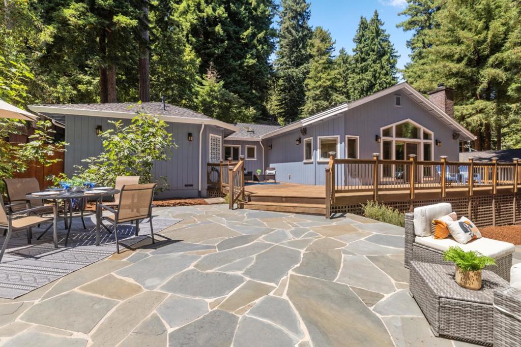 Discover your dream home in the picturesque mountains of Ben Lomond! This exceptional home features three spacious bedrooms and three luxurious bathrooms with additional office. Thoughtfully designed with premium finishes throughout, all adorned with exquisite marble, granite, and stone. Bathed in natural light and accentuated by soaring cathedral ceilings with sweeping redwood views, the interior exudes elegance and warmth. Premium features include two fireplaces, walk-in closet, heated floors, solid core doors, touchless sink, indoor outdoor speaker system and so much more than can be mentioned; this home exudes thoughtful design and elegance throughout. No upgrades needed, simply move in and start enjoying your luxurious mountain lifestyle. The open-concept living area seamlessly connects to a modern kitchen and additional wet bar, making it perfect for entertaining family and friends. Step outside to find a beautifully landscaped garden and a generous outdoor living space with pizza oven, ideal for relaxing or hosting gatherings against a backdrop of breathtaking mountain views. Conveniently located just minutes from local shops, hiking trails, and the charming vibe of downtown Felton and Ben Lomond, this home offers the perfect blend of tranquility and convenience.