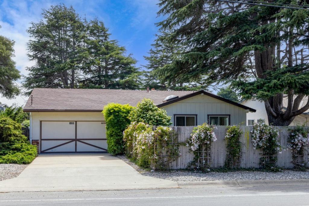 Make Carmel part of your own distinguished legacy. Here within an established neighborhood at the base of picturesque green mountains, this attractive property in the Carmel Unified School District sits ready to help you achieve a balanced, healthful lifestyle. A single-level residence built in 1956, it has been maintained in turn-key condition for its next owners, who will revel in this prime spot minutes from beaches and downtown Carmel-by-the-Sea. With scenic biking trails, peaceful nature paths, and Barnyard Shopping Center around the corner, outlets for exercise, adventure, good food and fun are always close at hand. Find your front entry hidden behind a pink jasmine-shrouded privacy fence. Inside are light-filled rooms where each detail recalls a simpler time when things were made to last. A brick fireplace anchors the living room, offset by sliding glass windows on one side and, on the other, built-in bookcases to house your collection of rare first editions or cherished mementos. Step outside, where tiny birds sing and hop around a feeder as you explore the colorful profusion of flowering plants and lush foliage that encircles your impressively landscaped yard and patio. Here, embrace the Monterey Peninsula's storied past so that you can be part of its limitless future.