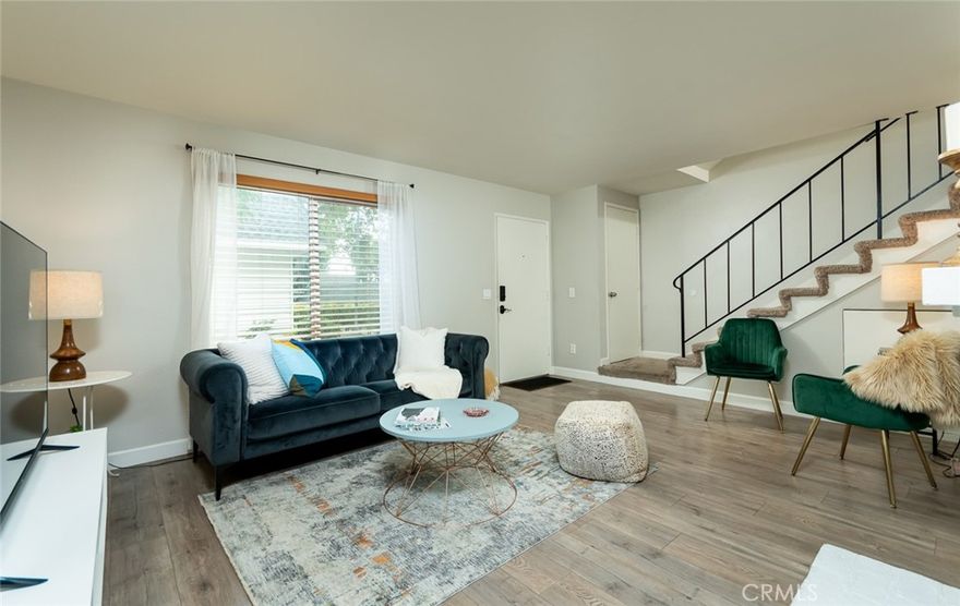 Welcome to this beautiful townhome inside the Devonshire Valley Community in the heart of Chatsworth. As you enter the spacious living room you are met by a cozy decorative fireplace to relax and entertain. Enter seamlessly into the open concept dining room and kitchen area that offer plenty of cabinet space. Kitchen includes white shaker style cabinets, subway tile backsplash with quartz countertops and stainless-steel appliances. A separate laundry room and half bath are nearby. The dining room has sliding glass doors that lead to a private bright patio with direct access to your own two car garage with ample storage. Upstairs are three comfortable-sized bedrooms with mirrored closets that provide the right amount of space for everyday living. Two bedrooms share a bathroom with a tub and shower combo with a quartz countertop vanity. As you enter the relaxing primary en-suite you are welcomed with a wall-to-wall mirrored closet and large vanity. Unit has recessed lighting, new double paned windows, and HVAC system. The grounds include a community pool, rec room, and playground. It is conveniently located to parks and trails, highly sought-out schools, dining, shopping centers, Trader Joe’s, and easy access to the 118 Freeway.