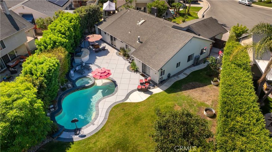 Nestled at the end of a serene cul-de-sac in one of South Huntington Beach’s most sought-after neighborhoods, this exceptional residence blends luxury, comfort, and coastal charm—just two miles from the beach via the river trail.



Set on a sprawling 9,100 sq. ft. lot, this beautifully appointed four-bedroom, two-bathroom home offers expansive indoor and outdoor living. The inviting fenced front patio welcomes you inside, where a gas fireplace creates a warm focal point in the living room. A formal dining room and open-concept kitchen and family room provide effortless flow, enhanced by a custom built-in desk and organization station ideal for today’s lifestyle.



Each of the three generous secondary bedrooms features custom closets, while a multi-purpose room offers flexibility and the potential to add a third full bathroom. The spacious primary suite is a private retreat, showcasing a dual-sided fireplace shared with the spa-inspired ensuite bath, complete with a soaking tub, walk-in shower, and dual custom closets.



Modern upgrades include air conditioning, a tankless water heater, and a gas range. Outdoors, the possibilities are endless—create your dream backyard around the resort-style pool and spa, greenhouse, and fruit trees including apple, lime, lemon, and avocado. With city-approved plans for an ADU, this property offers exceptional potential for future expansion or guest accommodations.



Surrounded by parks, trails, and friendly neighbors, this quiet enclave captures the essence of refined coastal living—where luxury meets lifestyle and every day feels like a getaway.