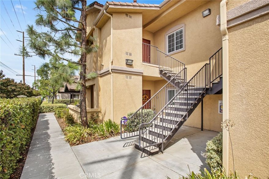 Discover effortless living in this meticulously maintained 2-bedroom, 2-bathroom condo, designed for modern comfort and style. The moment you step inside, you'll be greeted by an inviting, open-concept layout defined by stunning wood-style laminate flooring that extends throughout the main living spaces. The heart of the home is a bright and airy living room, centered around a charming fireplace with a tile surround, the perfect focal point for quiet evenings or casual entertaining. The kitchen is both practical and polished, featuring a full suite of clean white appliances and abundant counter space, ready for your culinary adventures. A convenient breakfast bar provides a seamless transition from the kitchen to the dining area, enhancing the flow of the space. Retreat to the spacious primary suite, a true sanctuary complete with a generous walk-in closet and a private en-suite bathroom. The second bedroom is equally versatile and well-proportioned, ideal for a guest room, a productive home office, or a personal gym. Experience resort-style living with an array of exceptional community amenities. Enjoy a refreshing dip in the sparkling pool, relax in the soothing spa, or stay active at the on-site racquetball court and fully-equipped gym. Added benefits include a 1-car detached garage for secure parking and extra storage, combining comfort with ultimate convenience. This home isn't just a place to live; it's a lifestyle upgrade, perfectly blending tranquility with a vibrant community feel. Don't miss the opportunity to make it your own.