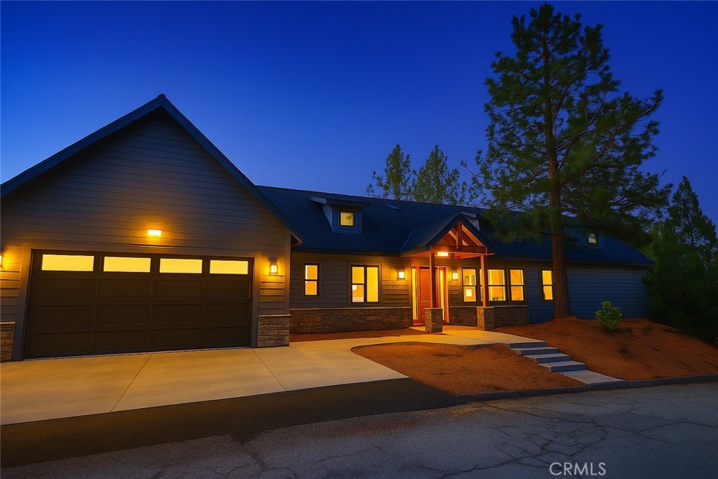 LEVEL ENTRY - NEW CONSTRUCTION. Experience elevated mountain living in this stunning, level-entry home located in the prestigious Oakridge Estates of Lake Arrowhead Woods. Thoughtfully designed with high-end finishes and an open-concept layout, this home combines modern elegance with the tranquility of alpine surroundings and expansive views. Enjoy seamless, step-free access from the garage directly into the kitchen, living room, and all main-level bedrooms—designed for comfort and convenience. The open concept kitchen offers Dexton stone countertop, premium appliances, instant hot water throughout, and custom alder cabinetry. The south-facing primary suite captures stunning mountain views and includes direct access to a spacious Trex deck for year-round outdoor living. The luxurious primary suite offers a spa-inspired bathroom with a freestanding tub, large walk-in shower, dual vanities, and plenty of natural light. A split floor plan layout offers privacy, with two additional bedrooms connected by a stylish Jack-and-Jill bathroom. This new build is designed for true easy living with a full sized walk in pantry, dedicated home office, and a spacious den / bonus room which is located in the lower level. Benefit from the central air conditioning during hot summer days and cozy up with the modern gas fireplace and central heat during snowy winter nights. Whether you're seeking a weekend retreat or a full-time mountain residence, this home offers effortless living, elegant design, and access to all that Lake Arrowhead has to offer.