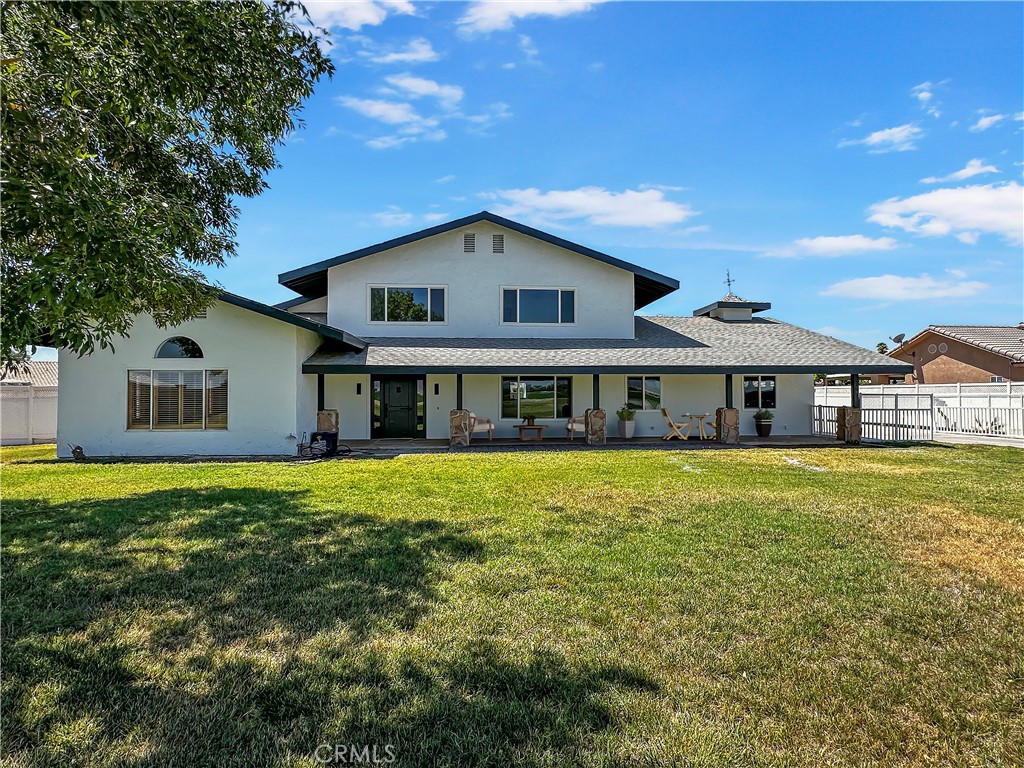 Discover your dream retreat at 650 W 10th Ave, Blythe, CA 92225—a stunning, fully remodeled 4-bedroom, 3-bathroom custom home nestled on a serene 1-acre lot with breathtaking mountain views and tranquil farmland across the way. This move-in-ready masterpiece blends luxury and comfort, featuring high-quality luxury vinyl plank flooring, a gourmet kitchen with white shaker and white oak cabinetry, a spacious island, induction stove, and dishwasher, and two cozy fireplaces—one in the inviting living room with built-in bookshelves and another off the kitchen. The downstairs primary suite offers private exterior access, a curbless shower, and a walk-in closet, while the upstairs primary suite boasts a lavish walk-in shower with three showerheads, a double sink vanity, and another walk-in closet. With an attached 2-car garage equipped with an EV charger, a detached 3+ car garage with a 50-amp RV plug, and a stackable washer/dryer included, this home is designed for modern living. Perfectly blending sophistication and peaceful rural charm, this one-of-a-kind property is ready for you to call home.
