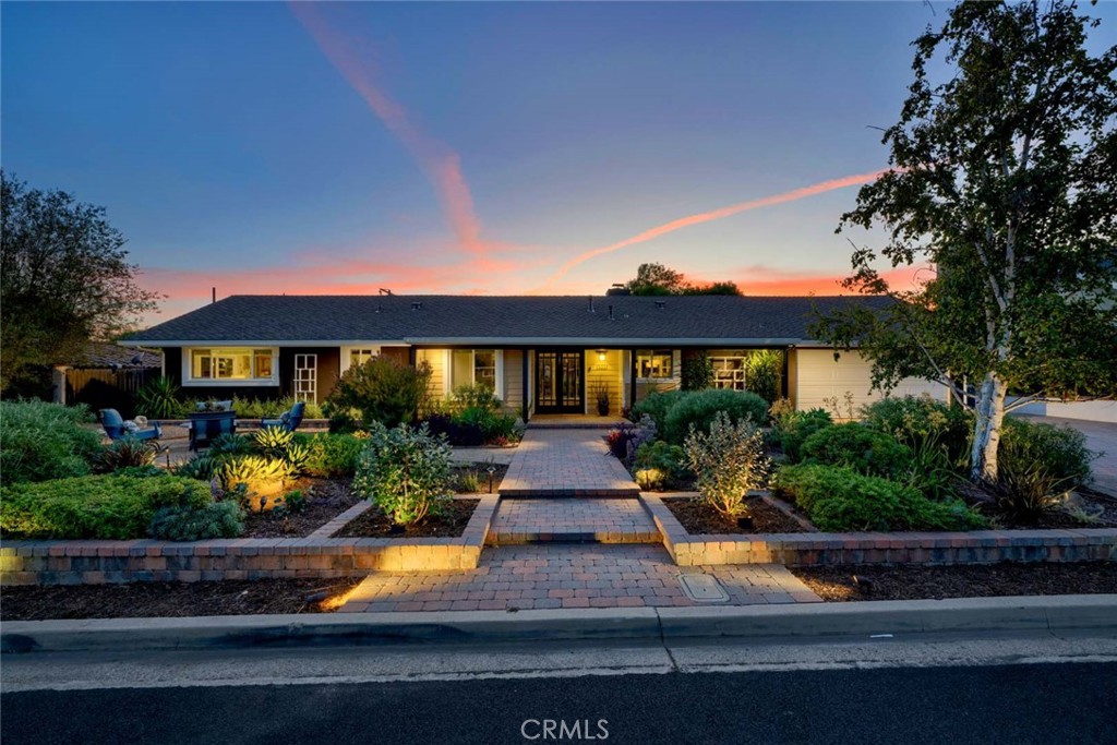 Welcome to 13051 Earlham Street, a Single Level Ranch Style Home Nestled on an Interior Lot in the Heart of North Tustin. This Dream Home was Fully Remodeled in 2019, Featuring Three Bedrooms, Two Bathrooms, Whole House Fan, Custom Built-Ins, Newer Water Heater, Dual Pane Windows, New Exterior Paint, and Countless Additional Upgrades Throughout. The Expansive Living Room Boasts a Shiplap Vaulted Ceiling, Stacked Stone Fireplace, and Opens to the Formal Dining Room with Floor to Ceiling Windows Overlooking the Backyard. The Gourmet Kitchen Enjoys Quartz Counters, Island with Seating, Soft-Close Cabinetry, Dual Ovens, and Opens to the Living Room/Dining Room Which is Perfect for Entertaining. The Spacious Family Room Includes a Vaulted Ceiling, Built-In Speakers, and Backyard Access. The Private Master Suite Boasts a Seating Area, Backyard Access, and Remodeled Master Bathroom with Dual Vanities, Makeup Vanity, Walk-In Closet, Walk-In Shower, and Separate Tub. Direct Access Two Car Garage with Built-In Cabinets Plus and Oversized Driveway. Remodeled Exterior Includes Lush Drought-Tolerant Landscaping, Commercial Grade Extra Thick Pavers, and a Sprawling Private Backyard Complete with a Large Patio, Two Pergolas, Built-In BBQ, Fire-Pit, Large Side Yard, Garden Beds, and Multiple Seating Areas. No HOA or Mello-Roos. Minutes to Highly Desired Tustin Unified Schools, Multiple Parks, Restaurants, and Shopping. Easy Access to 5/55/22 Freeways and 241/261 Toll Roads. 13051 Earlham Street is a Must See!