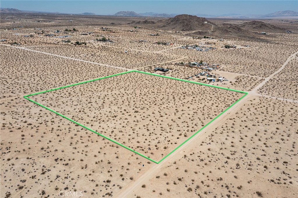 9.78-ACRES with NEW WATER MAIN. Fire hydrant and electrical nearby. North side of parcel borders La Brisa Dr – which reach paved Sunfair Rd to east and paved Border Ave to west. La Ferney Ave runs along the western side of parcel and Mountain Shadows runs along the eastern side for plenty of access. RURAL. Fantastic views of the mountain ridges of Joshua Tree National Park to the south. Vast wilderness and the ancient dry lake-bed below. Must see. NOTE: Green lines demarcating boundaries in pictures are approximate. APN: 0606-321-08