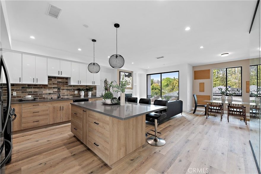 Welcome to this beautifully appointed townhome in the heart of Valley Village, where modern design meets everyday convenience. Featuring 3 spacious bedrooms, 3.5 bathrooms, and a dedicated office, this residence offers the ideal balance of comfort, style, and functionality. An open, light-filled floor plan showcases contemporary finishes throughout, with the gourmet kitchen serving as the centerpiece. It features a large island, quartz countertops, custom cabinetry, and premium stainless steel appliances. Perfect for entertaining or casual dining, the kitchen seamlessly connects to the expansive living area, which opens onto a private balcony overlooking the front of the property - an inviting spot to relax and unwind. 

Additional highlights include a direct-access 2-car garage, a charming front yard, and the convenience of an included washer, dryer, and kitchen appliances. Set on a picturesque, tree-lined street, this residence is within walking distance to shops and dining, with excellent access to the 170, 405, and 101 freeways. Just minutes from Universal CityWalk and major studios, this home delivers both a prime location and a refined lifestyle.