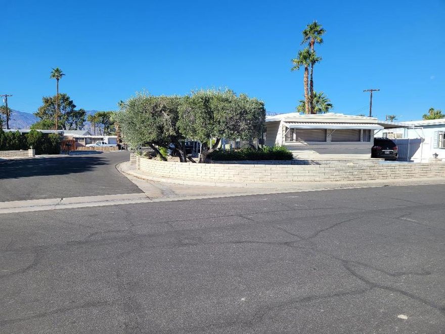 55+  Lovely home sits on large corner lot with large elevated patio to look at majestic mountains. There is parking on both sides of the house plus a one car garage. Two owners can play unlimited golf for one low monthly fee.  House has been cared for and has nice furnishings. You own the land. Walk to club house.  Plenty of sunlight inside and house has an open floor plan. Washer dryer are in the garage but there is also a laundry room inside.Tri Palms is in the most convenient location because it is close to Costco, Sams, Home Depot and restaurants, theaters and casinos. The Acrisure arena has world famous performers and also hosts the local hockey team.