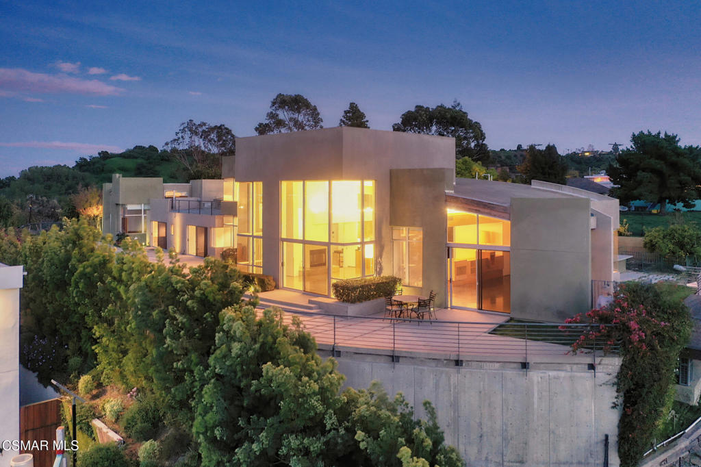 A Private Architectural Masterpiece in the SkyPerched high above the city with commanding, unobstructed panoramic views that stretch beyond the horizon, this one-of-a-kind custom-built concrete estate spans over 5,400 square feet of uncompromising elegance and design. A true architectural triumph, this secluded gated sanctuary was crafted for those who not only value total privacy but demand it and the finest things life has to offer.Every square inch of this home is a deliberate expression of artistry and refinement. From hand-carved, imported wood beam ceilings that whisper tales of old-world craftsmanship to radiant heated concrete floors that seamlessly blend luxury with functionality--no detail was spared. Soaring ceilings and expansive living areas flow effortlessly throughout, designed for grand-scale entertaining and intimate moments alike.The kitchen is not merely gourmet--it is legendary. Literally designed for one of the top five five-star chefs in the world, it is a culinary marvel equipped for both performance and presentation, boasting custom finishes, rare materials, and impeccable attention to detail.Natural light floods the home through floor-to-ceiling glass walls, transforming every moment of the day into a living work of art. The secondary en suite bedrooms are oversized and serene, offering mesmerizing views of the meticulously manicured backyard and surrounding landscape.The primary suite is beyond compare--an indulgent retreat with cavernous proportions, custom cabinetry, and a bespoke bedframe featuring a pop-up television reminiscent of the world's finest luxury penthouse suites. The jaw-dropping walk-in closet is a boutique experience unto itself, and dramatic windows frame your view of the shimmering pool and sprawling entertainment spaces.Step outside into your own private resort. A spectacular pool, elevated Jacuzzi, and limitless views transport you to another world. And then, there's the rooftop deck--an expansive sky-lounge that places you seemingly in the clouds. Whether hosting unforgettable soirees or enjoying quiet stargazing, this space elevates living to an entirely new level.Minutes from the vibrant heart of Sherman Oaks and the elite enclave of Beverly Hills, yet feeling worlds away--this home is not just a residence, it is an experience. A rare and remarkable opportunity for those who not only appreciate luxury but expect it.You've arrived. Welcome home.