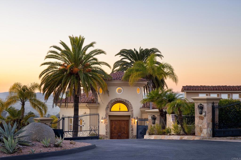 She's back and valued better than ever...Welcome to your very own White Lotus! Enjoy vacation vibes everyday with your very own private resort nestled above Lake Poway. Spanning 5,062 SF on 1.3 acres of beautifully landscaped terrain, this architectural marvel offers five bedrooms and six baths, seamlessly combining elegance with modern amenities. The property boasts incredible attention to detail, including towering Canary palms and a variety of vibrant greenery. Experience luxury with an impressive 70,000-gallon pool and spa, complete with a waterfall and a winding waterslide, along with multiple entertaining patios, gas fire pits, a grand outdoor wood-burning fireplace, and a professional-grade basketball/pickleball court. The estate offers remote-controlled pool, spa, outdoor lighting, and irrigation systems for your convenience. With a grand turret entry, spacious circular driveway, and an attached four-car garage, the gated property provides breathtaking views from its premium, end-of-cul-de-sac location on a west-facing hillside. Inside, you'll find a home boasting enviable architecture with soaring ceilings reaching up to 14 feet, complemented by elegant columns and arches. The entire design is crafted to maximize natural light through strategically placed windows, including an indirect light channel with both east and west-facing panoramic views. The residence also includes a chef's kitchen ideal for culinary pursuits, a wine cellar for the connoisseur, and a state-of-the-art movie theatre for ultimate entertainment. The time is now to indulge in the opportunity to create the ultimate vacation in your own backyard.