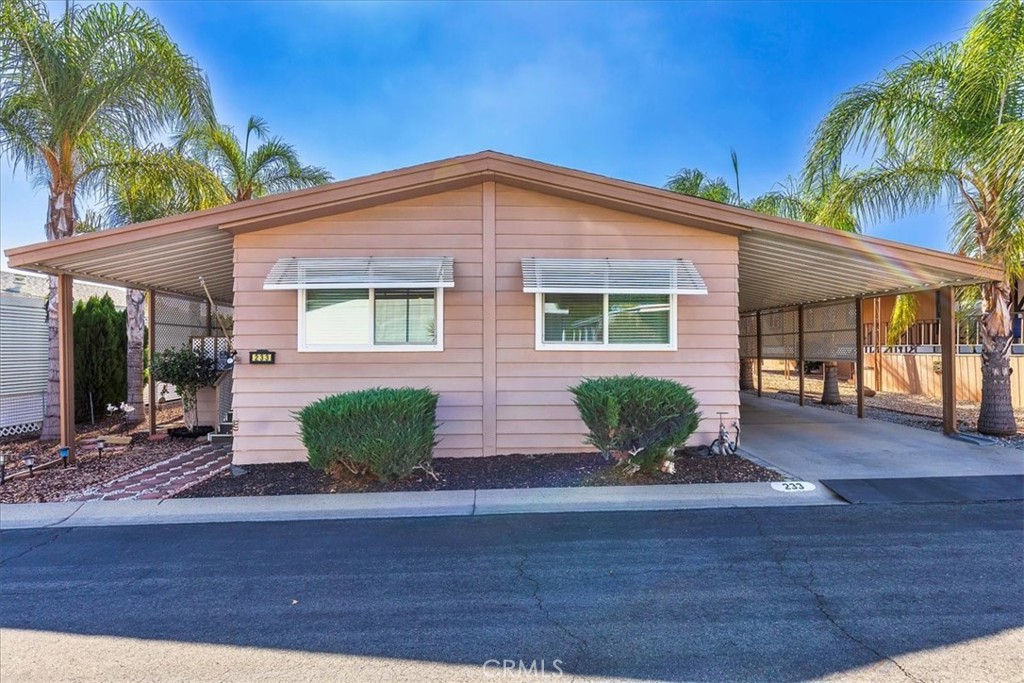 55+ Hillside Mobile Home Estates - Gated community - CLEAN/TURNKEY - 2 Bedrooms/ 2 Baths - Skyline Custom Golden Model manufactured home with approximately 1,344 square feet of interior living space. Features include an open floor plan with large living/dining great room with wood flooring. Kitchen with five burner gas stove top with exhaust vent hood - dishwasher - disposal, vinyl flooring (the countertop microwave & refrigerator can be included). Lots of cabinet & counter space with breakfast bar. Primary bedroom with wood floors - ceiling fan - walk-in closet. Primary bath with walk-in shower - single sink vanity. Guest bedroom with wood floors - wardrobe closet & built in dresser. Guest bath with shower in tub - single sink vanity. Indoor laundry room (with washer & dryer that can be included). Additional features include: Neutral interior paint through out, window blinds, ceiling fans, central AC & Heat. Covered front porch with privacy lattice, low maintenance yard, fruit tree. Detached storage shed within the covered carport & driveway. Community amenities include - Club House -Community Pool - Fitness Area - Billiards/Game Room - Sports Court - BBQ & Picnic Area. Conveniently located close to freeways, shopping, restaurants & more.