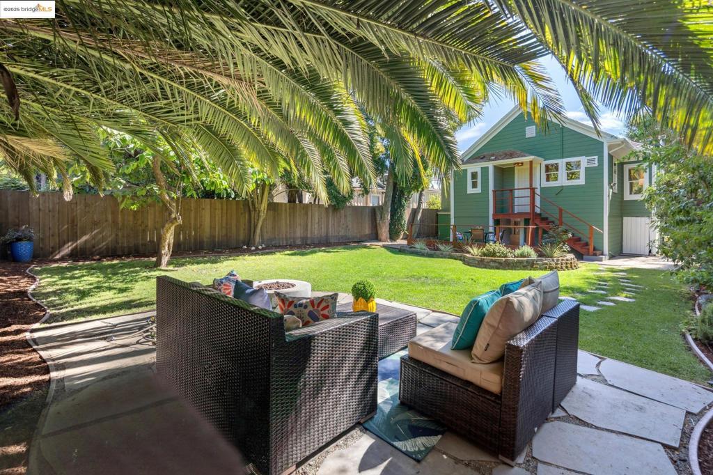 Introducing 3240 Nicol Ave in warm and sunny Oakland! This 885 sf classic farmhouse features 2 bedrooms, 1 bathroom and is situated on a generous, flat 3,745 sf lot offering a private backyard oasis flanked by mature trees and a sprawling, verdant lawn. Upon entering, you're greeted by a cozy living room with tons of natural light, refinished original hardwood floors throughout and a wood-burning fireplace. The living room gives way to a formal dining area with treetop views from every window. The updated kitchen with stainless steel appliances, stone countertops and modern cabinets make cooking and entertaining look as good as it feels. Behind this classic charmer, an enormous green yard beckoning you to unleash your inner gardener or set the stage for endless outdoor fun. Whether you're savoring a morning coffee on the back deck or hosting a backyard BBQ, this private outdoor space is your personal sanctuary. With proximity to the bustling Laurel and Dimond districts, you'll find plenty of shopping, dining, and entertainment options in the neighborhood while also offering local and transbay transit options making your commute anywhere in the Bay accessible and easy. Don't miss your chance to call this Oakland gem home!