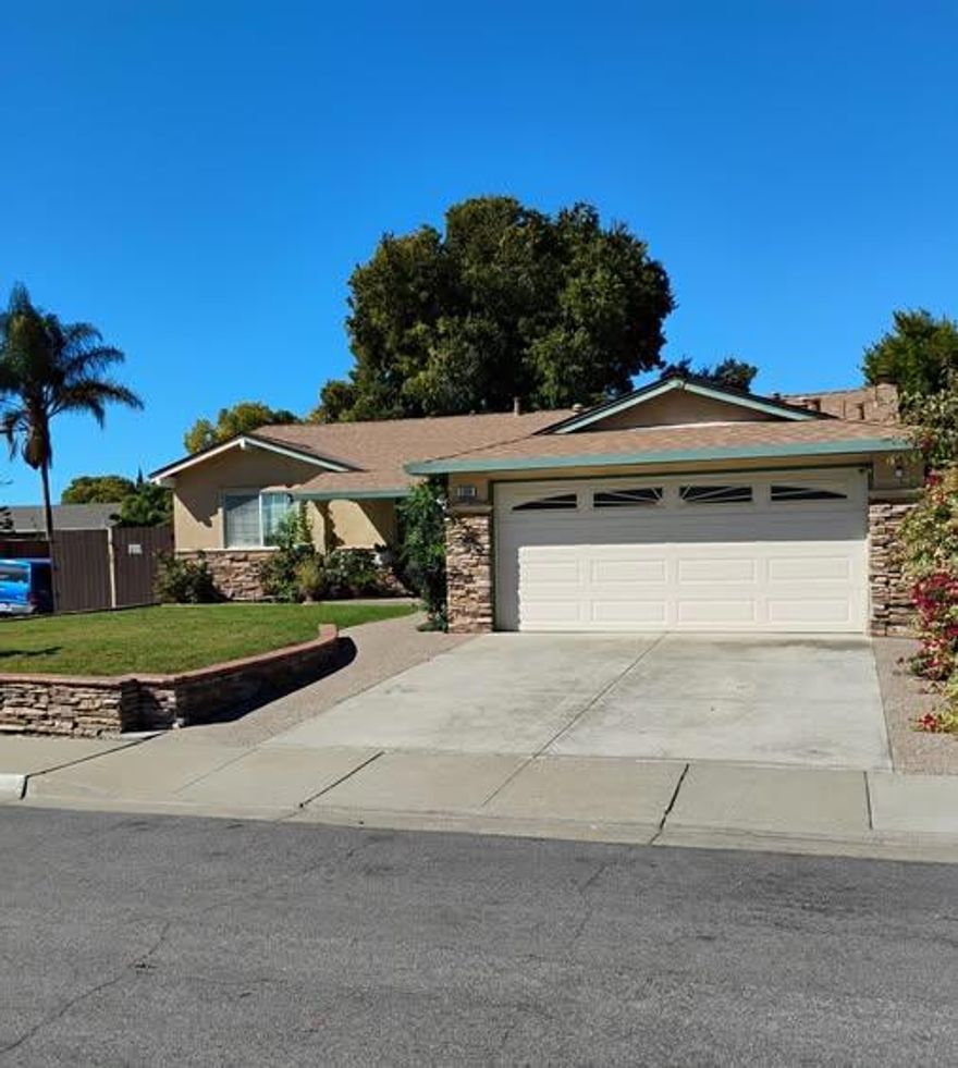 This rarely available 4 bedroom ranch style is located on a spacious corner lot. The kitchen has a much sought after gas stove, a lovely garden window, and an eat in kitchen area. Both bathrooms are updated, and the primary bathroom is remodeled. This home comes with all appliances including washer and dryer. There are both laminate and hardwood floors and an amazing natural rock/stone fireplace. With a 2 car garage, there is also rarely available two separate driveways for this home,  one goes to the garage, the other to the back yard.