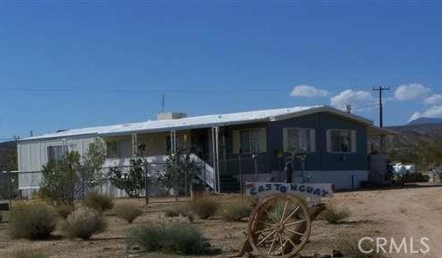 Perfect Desert Getaway! Good sized 2 bedroom 1 bath home located on 2.5 acres in a secluded area not far off the paved road with panoramic views. Also a separate Manufactured home 3 bedroom 2 bath sq ft approx 1044 (storage only). Horse corrals are included it is set up for horses and other animals. Room for RV, trucks or toys. Prime level lot with desert and mountain views all around. On city water and power. Great for extended family, rental. Just minutes to the Hammer Run. Must see to appreciate. Come take a look, you'll fall in love with the desert!