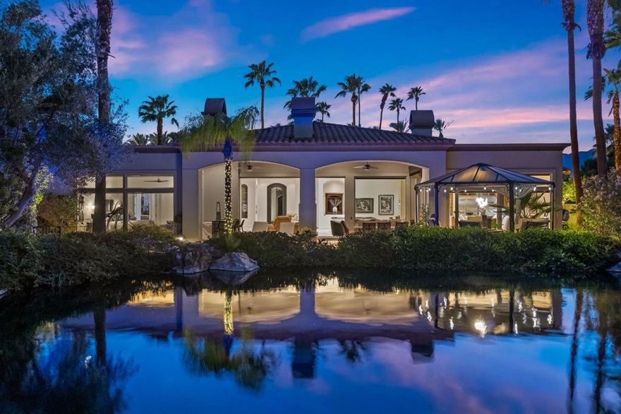 Set within the private enclave of Desert Falls Estates, this exceptional residence is one of only eleven homes located on a tranquil lake with fountains and sweeping mountain views. A showcase of craftsmanship and thoughtful design, this custom-built 4-bedroom, 6-bath, 5,172 square foot estate--including an attached casita--offers an elevated desert living experience defined by luxury, comfort, and privacy.The home's architectural elegance begins with a new wrought-iron gate leading to a serene courtyard. Once through the newly installed commercial grade glass front door, high ceilings, smooth-finish walls, and sophisticated lighting create an atmosphere of contemporary refinement. Every detail has been curated to the highest standard--from travertine flooring throughout and new kitchen cabinetry to custom shutters, electric shades, and designer chandeliers.The gourmet kitchen features all-new Wolf/Viking appliances, granite countertops, and a striking new backsplash. Entertain with ease in the full wet bar complete with wine fridges, ice maker, and beer tap, or gather in the dining room beside a newly added linear fireplace with a stacked stone feature wall. The seamless indoor-outdoor flow with stacked sliding pocket doors leads to a resort-style backyard with a hybrid-heated pool and spa, misting system, and a state-of-the-art outdoor kitchen with dual BBQs, wok burner, and shaded lounge area.Every upgrade was made with precision and care: 52 seller-owned solar panels, three new AC units plus a split system in the garage, hybrid pool heater, new Midwest windows, and an AVIR sound system with five high-end TVs. The two-car garage plus golf cart garage features ductless air and new openers for added convenience.Located moments from premier golf, shopping, and dining, this home blends modern luxury with the serenity of a private lakeside retreat--offering an unparalleled opportunity to live beautifully in Desert Falls Country Club. Call to schedule your private viewing today!