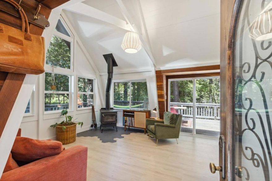 Milled and framed locally sourced timber this fully renovated A-frame retreat blends timeless charm with contemporary Scandinavian style, featuring clean lines, a minimalist palette, and natural light throughout. In the kitchen thoughtfully installed and designed custom cabinetry features pull outs and new high end appliances. In the bedroom you will find custom redwood furniture built locally and assembled in place that conveys with the home. Upstairs, a cozy loft adds flexible space perfect for a home office, yoga studio, reading nook, or playroom. Venture outside onto the expansive redwood deck ideal for summer BBQs and entertaining. The sun filled garden offers a peaceful space for gardening enthusiasts. Ample parking includes space for up to three vehicles, including room for an oversized car or camper. Enjoy a private well producing 8 gallons per minute with clean water from the heart of the mountain. You're just minutes from downtown Ben Lomond, with easy access to beloved local spots like La Placa Bakery, Aroma, and Spanky's Diner as well as shopping and top-tier hiking/ mountain biking trails and a local waterfall! Commute with ease as Silicon Valley 35 minutes away, and the beaches of Santa Cruz 20 minutes down the road. This is more than a home, its a lifestyle.