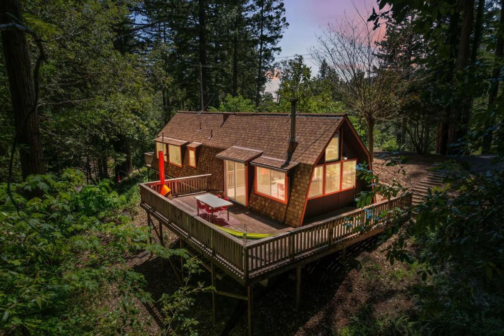 The iconic A-frame architecture is pure joy much like cruising in a two-seater convertible through the scenic roads that lead to 310 Sunny Patch Ln. It's hard not to smile. This fully renovated 1 bed / 1 bath A-frame retreat blends timeless charm with contemporary Scandinavian style, featuring clean lines, a minimalist palette, and natural light throughout. In the bedroom you will find custom furniture built with locally milled redwood. Upstairs, a cozy loft adds flexible space perfect for a home office, yoga studio, reading nook, or playroom. Venture outside onto the expansive redwood deck crafted from locally sourced timber ideal for summer BBQs and entertaining. The sun filled garden offers a peaceful space for gardening enthusiasts. Ample parking includes space for up to three vehicles, including room for an oversized car or camper. Enjoy a private well producing 8 gallons per minute with clean water from the heart of the mountain. You're just minutes from downtown Ben Lomond, with easy access to beloved local spots like La Placa and Aroma, as well as shopping and top-tier hiking/ mountain biking trails and a local waterfall! Commute with ease as Silicon Valley 35 minutes away, and the beaches of Santa Cruz 20 minutes down the road. This is more than a home, its a lifestyle.