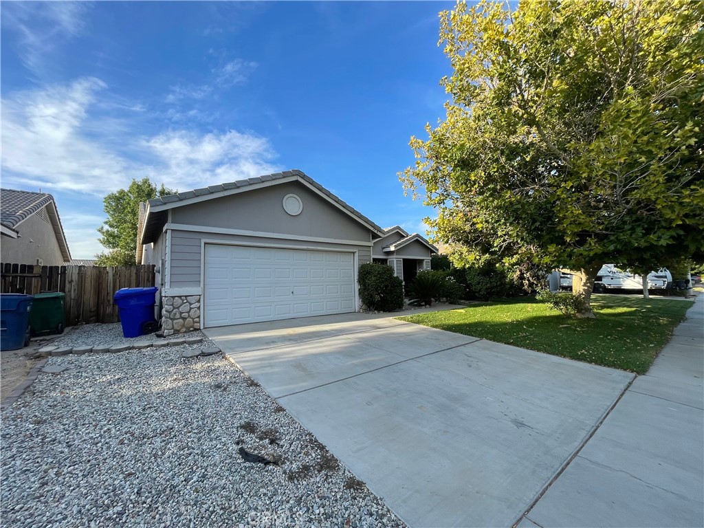 Spacious Lancaster Home! This 3-bedroom, 2-bath residence offers 1,880 sq ft of living space on a 5,661 sq ft lot, built in 2000. The large primary suite features dual closets and an ensuite bath. Enjoy a cozy fireplace in the living room, an open-concept layout with a breakfast bar, and tons of natural light throughout. The home also includes a laundry room with storage cabinets, direct access from the 2-car attached garage, and a beautiful covered patio overlooking the nice yard—perfect for outdoor entertaining. Conveniently located near schools, parks, shopping, and commuter routes, this is a wonderful opportunity to own in a desirable area! Call your Realtor to schedule a tour and make an offer today!