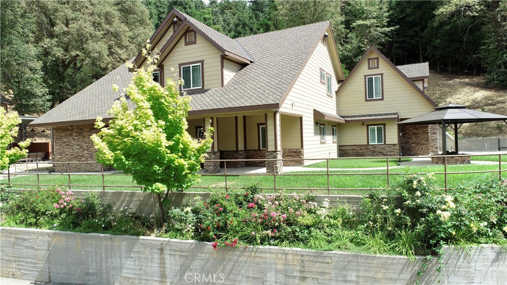 If you are looking for LOT'S of garage space and land this will be the perfect home for you! Stunning custom built mountain home with beautiful mountain views. This beautiful structure is 5,500 sqft and located on 3 acres. It has 5 bedrooms 3 1/2 baths. On the main entry level is the master suite with a stone fire place, oversized walk in closet, large bathroom with jetted-spa tub along with access to the large covered back patio. One guest bedroom, 2 1/2 bath and utility room also on the main level. Main entry has custom marble flooring and beautiful wood stair case with a custom stone wall that leads to the second level with theater room, gym room, office, 3 guest bedrooms and 1 full bath. As you walk in the in to the grand living area a beautiful stone fire place awaits. The kitchens granite counter tops, large pantry, double oven with warmer is a big family's holiday dream with a plenty of space for any occasion. A large 30x60 covered outdoor bar, covered bbq area with 3 outdoor fire pit areas to entertain and stay warm year round. Main home has two tankless water heaters and a dual zoned HVAC system along with plenty of garage space for storage and toys. Detached 5 car garage with large loft has a 5 ton HVAC unit, 2 car garage attached to home and another detached deep garage located behind main house.