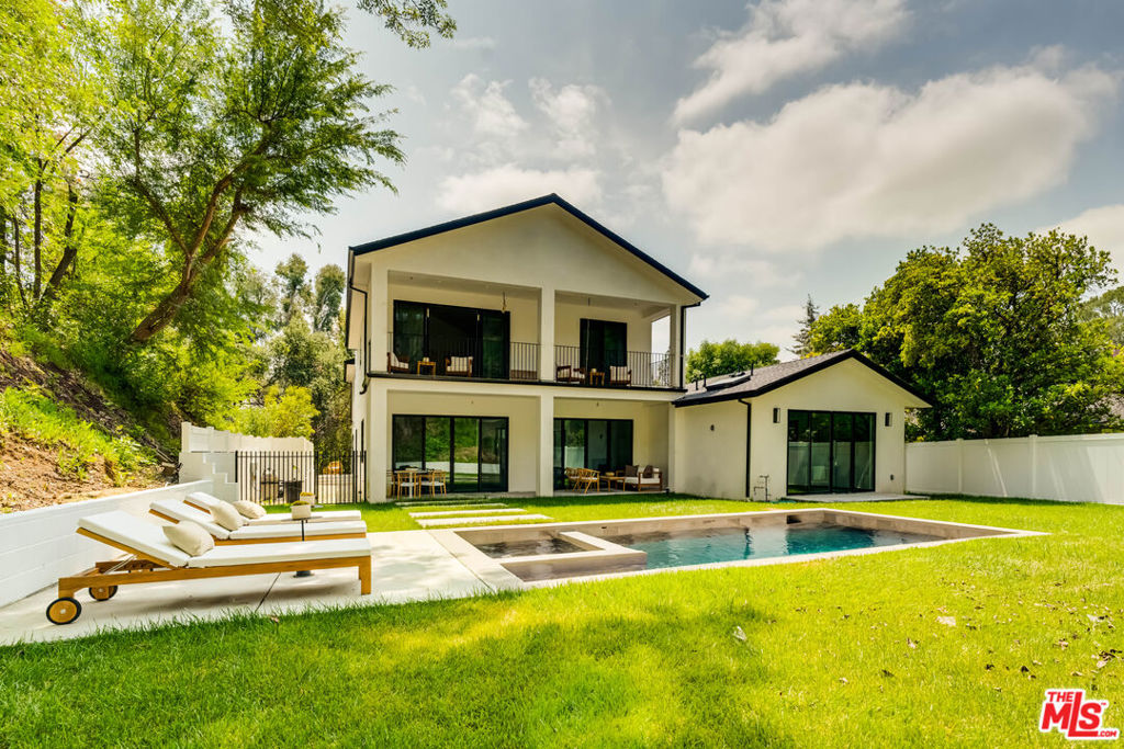 Tucked at the end of a quiet cul-de-sac in the prestigious Lanai School District, this newly built modern farmhouse offers the perfect blend of luxury, comfort, and privacy. With a total of 4,515 square feet, the property includes a 4,100 sq ft main residence and a 415 sq ft fully equipped ADU ideal for guests, extended family, or rental income. Designed with clean lines, natural textures, and thoughtful open-concept living, the home features 6 spacious bedrooms and 7 designer bathrooms. The gourmet kitchen is a showstopper with custom cabinetry, and an oversized island that flows seamlessly into the expansive living and dining areas. Fleetwood doors open to a beautifully landscaped backyard oasis perfect for indoor/outdoor living with space for entertaining, lounging, and enjoying California's year-round sunshine. Just minutes from Ventura Blvd yet tucked away in a peaceful enclave, this exceptional home offers both elegance and convenience in one of Encino's most sought-after locations.
