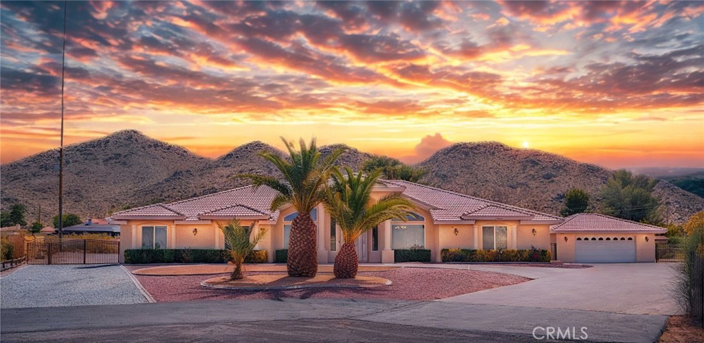 Welcome to your dream home nestled at the end of a peaceful cul-de-sac in the beautiful and prestigious Upper Desert Knolls area of Apple Valley. This stunning 3,356 sq. ft. residence offers 4 spacious bedrooms (potential 5th bedroom), 2.5 bathrooms, sits on a generous .551-acre lot and has PAID OFF SOLAR– the perfect blend of privacy, comfort, and functionality. A unique detached 2-car garage – perfect for a workshop, additional storage, hobby space, or even a potential ADU conversion. Plus, step inside to discover an open floor plan designed for modern living. The bright and airy family room is highlighted by a cozy fireplace and expansive windows that flood the space with natural light. The heart of the home, the kitchen and adjoining living spaces, flow effortlessly together, ideal for gatherings and everyday living. The kitchen offers plenty of counter space, lots of cabinetry for storage, along with canned lighting and updated counter tops. Retreat to the massive master suite, your own private sanctuary complete with a second fireplace, oversized soaking tub, separate stand-up shower, and a generous walk-in closet. Additional features include indoor laundry, ample storage throughout, and PAID OFF SOLAR, helping you save on energy costs while keeping the home efficient and eco-friendly. Outside, the expansive lot provides RV Access. Don’t miss this rare opportunity in Apple Valley – schedule your private tour today!