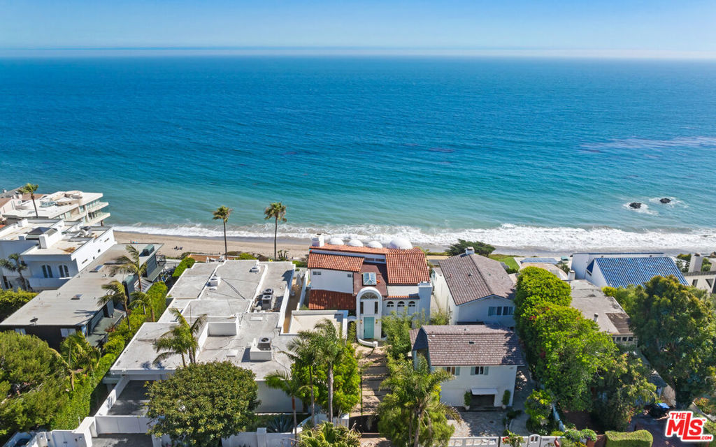 Welcome to your dream coastal retreat! As you enter through the gated driveway, which offers parking for 3-4 cars, you'll be greeted by a beautifully landscaped front yard featuring a charming fountain. The large front door immediately reveals stunning ocean views, complemented by the elegant wood floors and a state-of-the-art ring and door bird system. The turnkey home boasts high wood-beamed ceilings with a skylight, adding to the airy and bright ambiance. Descending the steps to the main living area, you'll be captivated by the panoramic ocean views. To your right, a functional laundry room awaits, complete with a washer and dryer, sink, and stone counters. Adjacent is the family room, where ocean views, high ceilings, wood floors, and a sophisticated speaker system create the perfect space for relaxation. The family room seamlessly opens to the main living area, featuring high coffered ceilings, recessed lighting, wood floors, a gas fireplace, a Sonos system, automatic shades, and ample closet space. Sliding glass doors lead to an ocean-view deck, ideal for indoor/outdoor entertaining and enjoying the coastal breeze. This room also transitions effortlessly into the dining area and the exquisite kitchen. The kitchen is a chef's delight, offering stone counters, ocean views, wood floors, a stone island with bar seating, a Wolf range with a hood fan, built-ins, double Wolf ovens, a Sub-Zero fridge and freezer, an Asko dishwasher, a built-in breakfast nook with ocean views, and built-in benches. Additional amenities include a sink with a water filter line, a Wolf coffee maker, and a Sub-Zero mini wine fridge.The ocean-view deck features a fire pit, outdoor seating, and dining options for al fresco enjoyment.Returning to the entrance, a door leads to a cozy bedroom with wood floors, a fireplace, a separate entrance, a walk-in closet, and an en-suite bathroom with stone tile floors, a sink, vanity, and shower stall. Ascend the stairs to discover a versatile office area or second-story TV sitting room. Straight ahead lies another bedroom, offering panoramic ocean and coastline views, with mirrored sliding closet doors. To the left in the hallway, a full bathroom awaits, complete with stone counters, a double sink and vanity, a free-standing tub, and a shower stall. At the end of the hallway, another bedroom features wood floors, high wood-beamed ceilings, a sitting area, and sliding mirrored closet doors. Each room is equipped with Nest thermostats for optimal comfort.The master suite is a true sanctuary, boasting panoramic ocean views, wood floors, wood-beamed ceilings, a porthole window, sliding glass doors to the ocean-view deck, a walk-in closet with built-ins, and an en-suite bathroom. The master bath includes double sinks, a makeup vanity, an in-ground tub, a shower stall with steam and double shower heads, and a water closet. Outside, you'll find beach access steps, a detached one-car garage, a marble backsplash in the kitchen, air conditioning, a bench in the front yard, a 250-volt charger, a camera security system, and a Jacuzzi with ocean views. This home is a perfect blend of luxury and coastal living, offering unparalleled views and amenities.