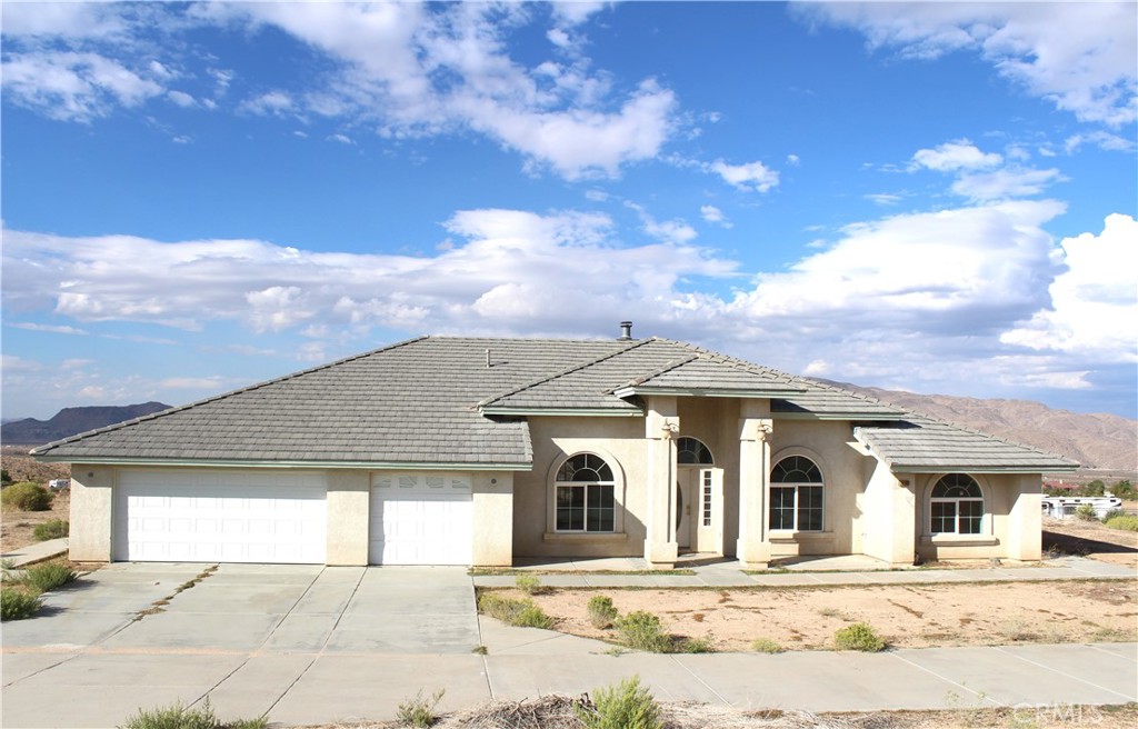 Mountain view home with BIG lots 2.27 Acres for your toys/livestock/ADU/workshop, etc. Equestrian, welcome! Entering the property through generous concrete driveway, three car garage with two gates welcoming you to 4 bedrooms and 3 full baths, formal dining room, living room and the family room with a fireplace. New carpet throughout and re-painted interior. Kitchen with granite counter tops, completed with an island. Dining area with beautiful mountain view. Backyard covered patio and fenced yard.
