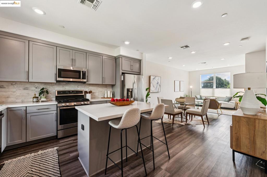 Stylish multi-level townhome in North Oakland’s Element home community built in 2019 with a grand list of innovative features and premium finishes coupled with beautiful modern design. This bright, light-filled home features 3 ensuite bedrooms, 3 full baths & 1 half bath across 1,556+/- SF of modern living, with attached 1-car garage and spacious private patio with lush backyard. Situated in the vibrant Longfellow neighborhood nearby shops and restaurants of the Temescal district, this home is the perfect fit for the homeowner with discerning style and sustainable lifestyle. The 1st floor features a spacious bedroom ensuite, private front door with street-level access, and entry from the attached garage. The main level welcomes you into a fabulous entertaining space with modern, open-concept chefs kitchen with island that flows into a large dining area and a bright and airy family room. The top level features 2 ensuite bedrooms with no detail overlooked. The primary ensuite is an owner’s sanctuary with a spacious closet and a spa-like bathroom. A 2nd ensuite bedroom, laundry room with washer & dryer, and ample storage complete this serene space. Walkability and accessibility are a hallmark of this next-level home with BART and transbay bus to SF just minutes away.
