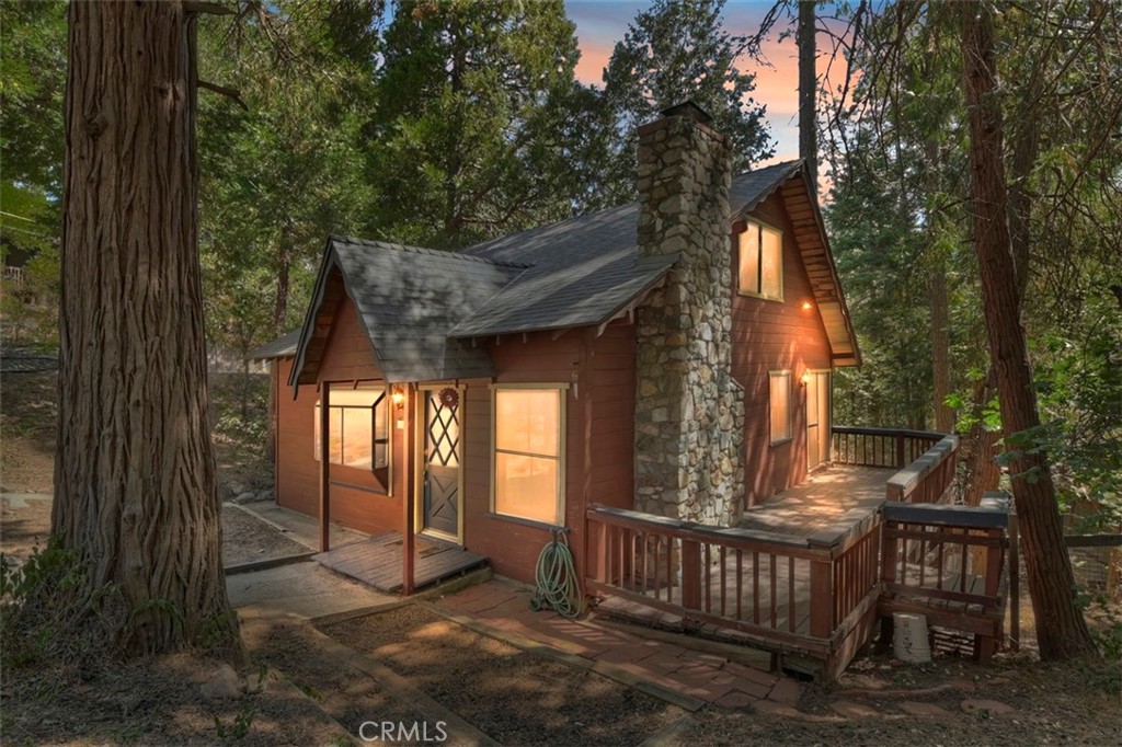 Charming cabin in the woods. This vintage cabin features 2 bedrooms plus a loft and 1.5 baths on a gently sloping lot in a great San Moritz neighborhood. The main level features a comfortable living room with original wood burning fireplace, tongue and groove paneling, wood beamed ceiling and updated flooring. Good sized kitchen with dishwasher, gas stove, breakfast bar and cozy dining area with slider out to the side deck. A full bathroom and separate laundry room complete the main level. Up the charming wood staircase you will find the secondary bedroom, loft and large primary bedroom with ensuite half bath. You can't beat the location and charm of this vintage cabin. Schedule your private showing today!