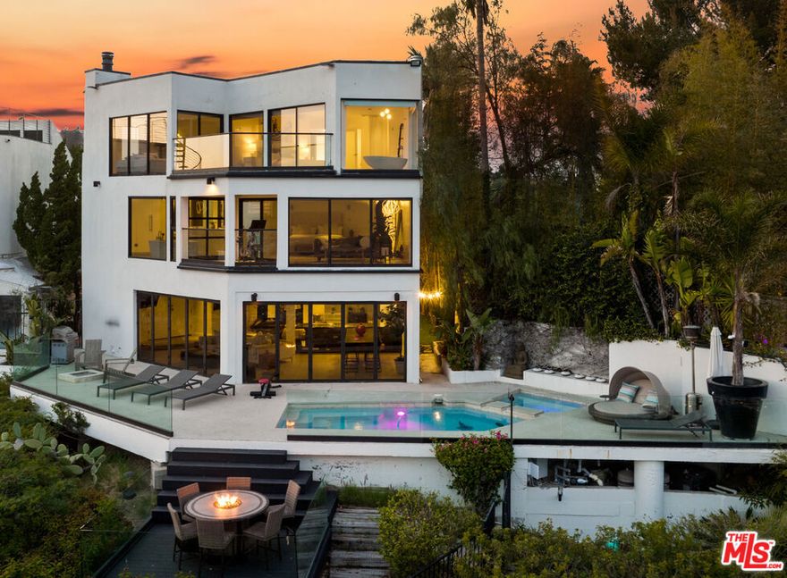 Stunning Architectural Estate in the Hollywood Hills with Spectacular Views fromDowntown to the Ocean! Walls of glass slide open from main living area to pool, spa, fire-pit which feels more like an outdoor living room so you can enjoy the ultimate California lifestyle. Open kitchen features high end appliances andmodern designer touches. Master bedroom is straight out of a movie set with afully open Italian style bathroom and jetliner views that will start any morning andend any night in style! Rooftop deck, putting green and hiking trail on theproperty that leads to private promontory point. Direct access 2 car garage with driveway for many more cars.  AVAILABLE FOR SHORT TERM AND MONTHLY - PLEASE INQUIRE FOR RATES.