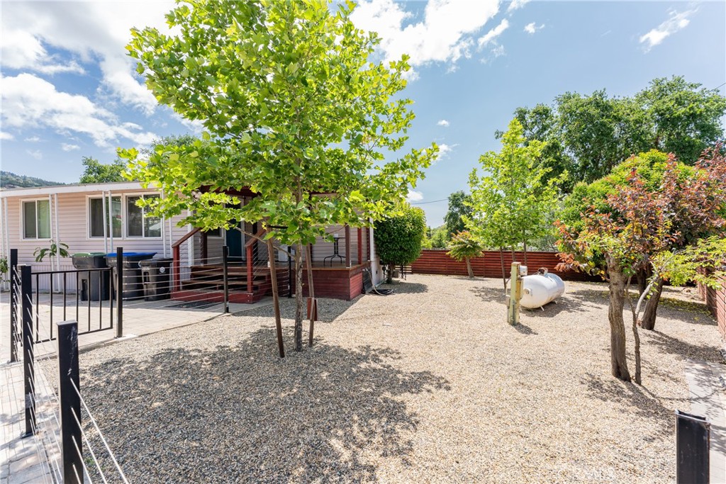 Tucked at the end of a quiet street, this charming single wide mobile home sits on its own land behind a secure electric gate offering privacy, space, and peace of mind. The full-length paved driveway and patio area comfortably fit up to 4 vehicles, with plenty of room left for BBQs, outdoor lounging, or even a fire pit hangout. Inside, you'll find an open floor plan with fresh, modern updates that make the space feel bright, welcoming, and functional. Just a quick drive from the lake perfect for weekend kayaking, fishing, or simply soaking up the scenery. And back at home, the fully fenced yard includes a separate area for dogs, a garden space, and storage shed for all your gear. The covered front porch is the perfect spot for morning coffee or relaxing after a day on the water. Affordable, practical, and full of personality this home is a great first step into ownership, with all the essentials and a little extra adventure right nearby.