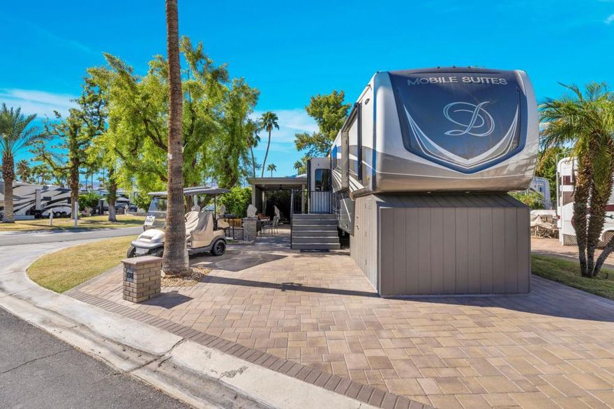 I am delighted to present an exceptional new listing: Lot 737  featuring an immaculate 2021 DRV Mobile Suites - Houston 44. This offering stands out as one of the most exquisitely appointed properties currently available on the market.This expansive corner lot has undergone significant investment, boasting approximately $70,000 in premium outdoor upgrades, ensuring a truly turnkey experience for its new owner. No further work or modifications are required; every detail has been meticulously addressed. The property features fully paved grounds for effortless maintenance and aesthetic appeal, complemented by a custom-built gazebo equipped with convenient electric blinds, ideal for relaxation or entertaining. Additional thoughtful amenities include an extra-wide, comfortable access stairs. The entire perimeter is embraced by mature hedges, providing enhanced privacy and beauty, alongside a comprehensive irrigation system for effortless landscaping care.Integrated seamlessly with this magnificent outdoor space is a next to new 2021 DRV Mobile Suites - Houston 44. This pristine unit, having seen minimal use, exemplifies luxury and thoughtful design. Step inside to discover a luminous, airy, and inviting interior, characterized by abundant natural light. Practicality meets elegance with a dedicated desk area, perfectly suited for remote work or leisurely activities. The unit is fully equipped with modern conveniences, including a dishwasher and an in-unit washer/dryer. The private quarters offer ultimate comfort with a cozy king-sized bed and a lavish walk-in bathroom suite, complete with dual sinks and an exceptionally spacious closet, providing ample storage and sophisticated comfort.This entire package represents an extraordinary opportunity, offering an unparalleled blend of exquisite outdoor living and the sophisticated comfort of a top-tier mobile suite. What a gorgeous package !