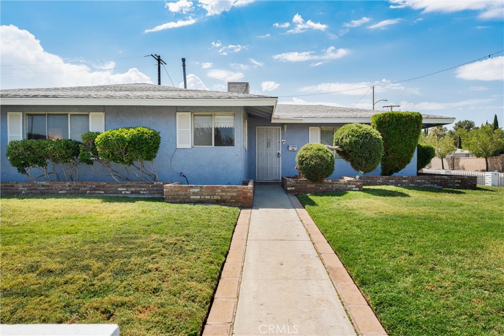 Lovely single story POOL home with tons of room and character! This 3 bedroom, 1 1/2 bath home originally included a two car garage, but the owner decided to convert that into an additional entertainment space with a bar! Dont worry, there's gated access and a driveway to park a small car on the side of the house and plenty of street parking. This home boasts new carpet throughout, spacious bedrooms and a low maintainance backyard with a sparkling pool. Located on a corner lot, it is walking distance from Target, 24 hr Fitness, various restaurants, Dutch Bros Coffee, Sprouts grocery store, a school and easy freeway access. Its located minutes from AV Hospital as well. Hurry, this one won't last long