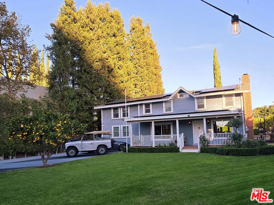 Discover the perfect balance of history, luxury, and modern family comfort in this truly exceptional unfurnished, 5BD / 5BA, 3,216 sq ft residence with beautiful 1BD/1BA ADU on a sprawling 14,000 sq ft lot. Originally the 1920 John Haskell Farmhouse, the property has been thoughtfully transformed with a Modern Farmhouse Chic aesthetic, creating a secure, private compound ideal for refined living and effortless entertaining. Inside, the inviting Primary Suite features a custom large closet and a spa-like bathroom with a dual-sink vanity and an oversized soaking tub. A separate spacious downstairs guest suite offers its own full bath and closet, while three additional bedrooms upstairs provide flexibility for family, guests, or office use. The heart of the home is the gourmet kitchen, equipped with a Wolf double oven, Sub-Zero freezer and refrigerator, and an impressive 10-ft island, perfect for casual meals, homework sessions, or gathering with friends. A formal dining room easily accommodates larger dinner parties and special occasions. Outdoor living shines with an expansive front lawn ideal for children and pets and a spacious backyard retreat featuring a 35' x 35' heated Baja step pool, a Viking BBQ with mini-fridge, and a fire-pit lounge area. Includes a dedicated pool bathroom with shower for convenience. The property is Smart Home and is fully secured with a gated driveway, keyless entry system, monitored alarm, and exterior security cameras. Additional highlights include driveway parking for six cars, Tesla charger, and a one-car enclosed garage with remote entry. Located just minutes from K-8 Hesby Oaks Charter School, local restaurants, and shopping, with easy access to the 101 and 405 freeways.