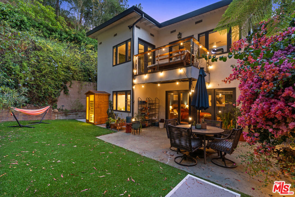 This is the peaceful Beverly Glen retreat you've been waiting for! Surrounded by nature and tucked away on a quiet, non-through street, this 1,978 SF 3BR/3BA home offers exceptional privacy and a seamless indoor-outdoor flow. Mornings begin with sunlight streaming through large windows and glass doors, leading to patios and decks from every bedroom. Off the kitchen, a private patio invites fresh air, hillside breezes, and the perfect spot for morning coffee or al fresco dining.The beautifully remodeled kitchen features a large island with seating, custom walnut cabinetry, abundant storage, and striking emerald Mexican tile that flows into the open living areaideal for cooking, gathering, and entertaining. On the main living floor, two bedrooms each have their own bathroom and share a charming patio, while the ground-floor primary suite boasts direct access to the outdoors and sauna, a spa-like bath with dual sinks, clawfoot tub, spacious shower, and huge walk-in closet. A functional laundry room is also conveniently located on the ground floor next to the primary suite.In the backyard, bright pink bougainvillea frames the outdoor dining area, while lush California-native landscaping and fruit trees (lime, lemon, pineapple guava, nectarine) create a serene setting with frequent hummingbird visits. With ample storage, parking for five, and a location just minutes to Beverly Hills, Century City, Westwood, and the Valley, this home is a peaceful sanctuary that perfectly blends nature, comfort, and style.