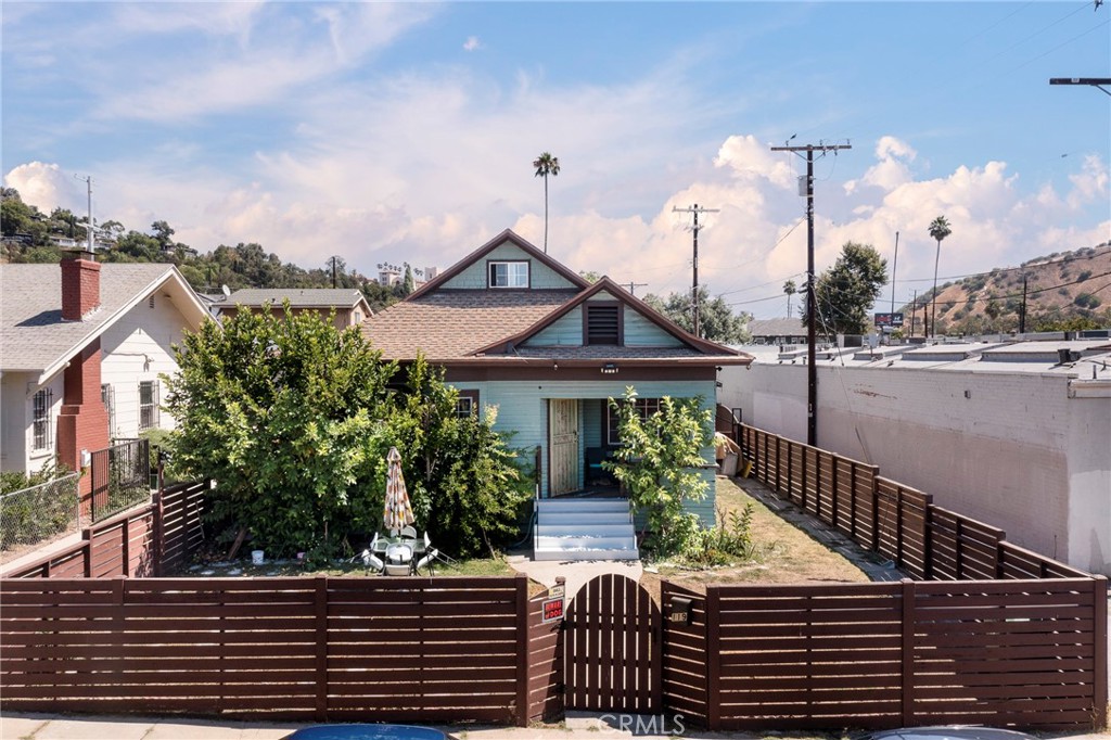 Welcome to this incredible duplex located in the desirable Montecito Heights area of Los Angeles situated on a cul-de-sac. The entire property is gated and the front home features a spacious front yard, a charming porch, and a welcoming foyer. Inside, you'll find three bedrooms and two bathrooms, along with a lovely living room and a kitchen equipped with granite countertops, stainless steel appliances, ample cabinet space, with dining area. Additional highlights include wood flooring, a laundry room, ceiling fans and access to a versatile attic space—perfect for a home office or extra storage. The back house also boasts a charming front porch and offers two bedrooms and two bathrooms. Its open-concept layout includes a bright living room, dining area, and a kitchen with granite countertops. A separate indoor laundry room is also included. The property features a detached two-car garage and additional parking for several vehicles. Both units have separate meters and water heaters for added convenience. Ideally situated just off Figueroa, this duplex is close to trendy shops, local restaurants, and provides easy access to the 5 and 110 freeways. It's just minutes from Downtown LA, Elysian Park, and Dodger Stadium—making this a fantastic opportunity for both investors and owner-occupants.