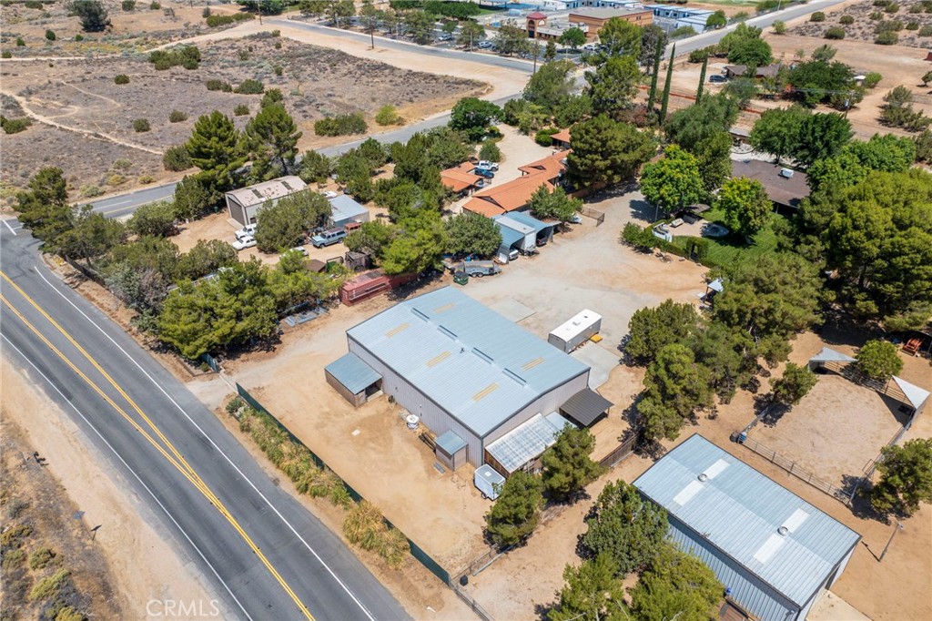 A once in a lifetime find. 1.34 flat acres in Central Acton. 1883 sq ft house with 4 bedrooms and 2 baths. 400 Amp electrical panel. 2 car attached garage. Also includes a large detached metal shop at just under 4000 sq ft. Electric gates at Soledad and at Sacramento st. Perfect set up for storing 2 large RVs or boats indoors. Shop has a car lift, 2 bathrooms. a upper level bedroom suite and a downstairs music room, kitchen, bar and laundry, ample electric, while still allowing for indoor storage. Lush manicured landscape. Custom fencing and gates. Outdoor kitchen area. Covered car ports. Ample outside parking. Small sports court. Chicken coup. Accessory buildings. Plush garden area. Too much to list. A MUST see property. County water and natural gas. Paved road access. Commuter friendly. Come for a visit. Stay for a lifetime. Welcome home.
