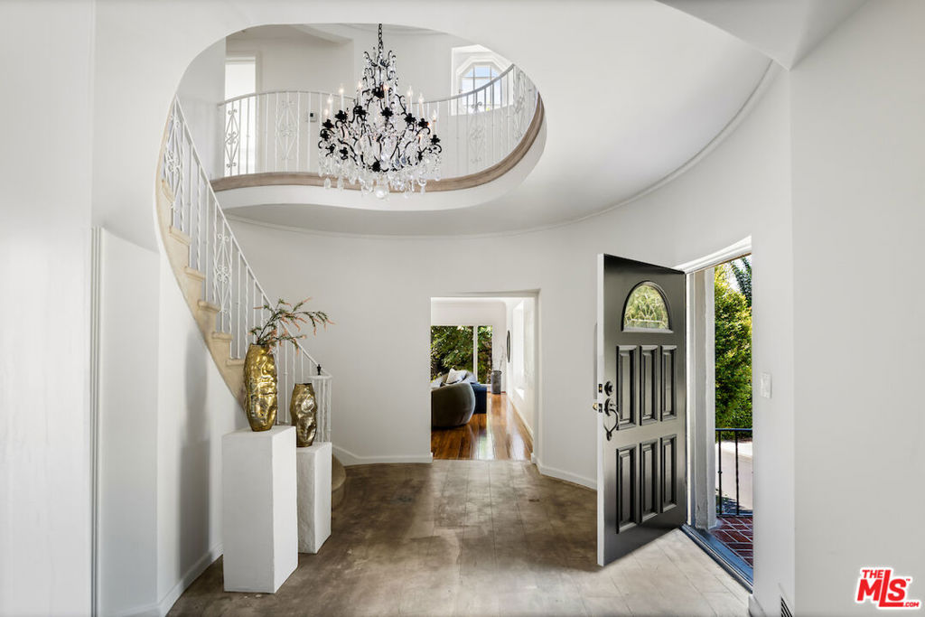 Step into this magnificent 1939 Traditional residence located in the highly desirable "The Oaks" neighborhood of Los Feliz. This distinguished home offers timeless sophistication. Designed by the renowned Los Angeles architect Benjamin L. Wiseman. Situated on an expansive corner lot, this four-bedroom, four-bathroom property showcases graceful proportions, impressive architectural details, and a touch of Old Hollywood glamour. It is a truly rare gem within one of Los Angeles's most sought-after enclaves. The interior features a grand entry hall with a sweeping staircase, a richly wood paneled library complete with a fireplace and a charming Dutch door that opens to the pool and spa, gleaming hardwood floors, intricate mouldings, and meticulously preserved details throughout, creating a sense of refined luxury. With its architectural pedigree, refined craftsmanship, and undeniable Old Hollywood allure, this home captures the romance and prestige of a bygone era while offering the comfort and sophistication of today. Its generous scale and flowing layout are ideal for both comfortable daily living and entertaining. ***FIRST SHOWINGS WILL BE ON SATURDAY 8/16 AND SUNDAY 8/17 FROM 1-4 pm. ***