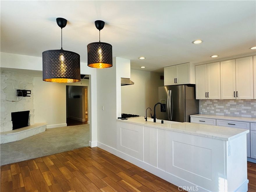 Welcome to this beautifully upgraded 4-bedroom, 3-bath single-level home, offering the perfect blend of comfort, style, and seamless indoor-outdoor living. Step into a spacious living room featuring a striking fireplace and built-in wiring for your flat screen TV—ideal for cozy nights or entertaining family and friends. The remodeled kitchen is both sleek and functional, flowing effortlessly into the light-filled dining area with direct access to the backyard. Enjoy views of the sparkling pool while you cook or dine. All 3 bathrooms have been tastefully updated with modern finishes that enhance the home’s contemporary aesthetic. Each of the four bedrooms offers generous space, large windows, and abundant natural light. The primary suite is a peaceful retreat with private backyard access—perfect for morning coffee or a relaxing evening swim. Outside, enjoy your own private outdoor living area, complete with a sparkling pool and landscaped yard, ideal for both entertaining and unwinding. Glass sliders connect indoor and outdoor spaces for effortless year-round enjoyment. A spacious front patio adds even more room to relax or host gatherings. The oversized driveway provides ample parking for multiple vehicles. Located in a highly desirable neighborhood near parks, schools, shopping, and the university, this home is move-in ready and waiting for you to enjoy!